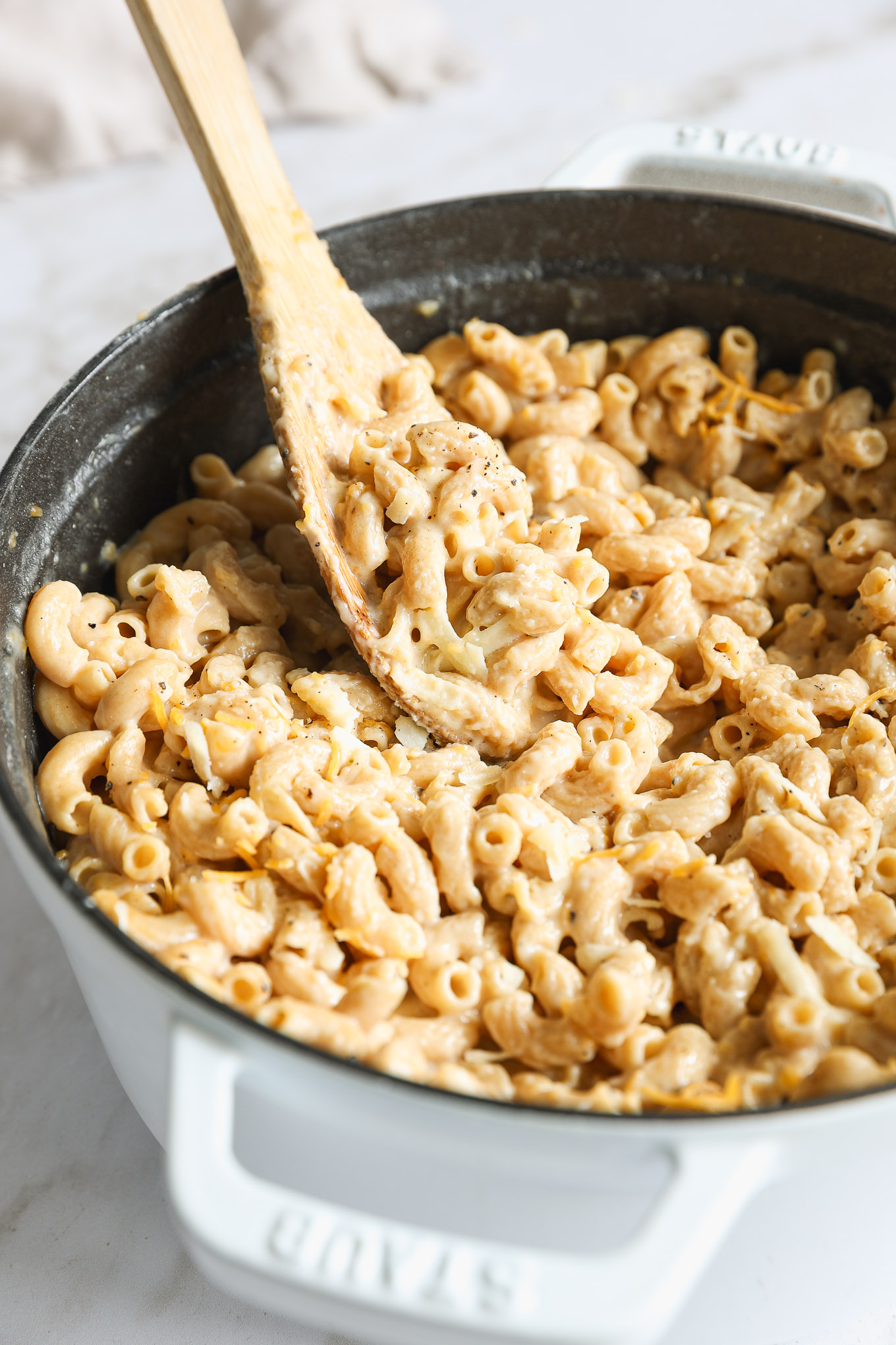 close up whole wheat macaroni and cheese with a spoon.