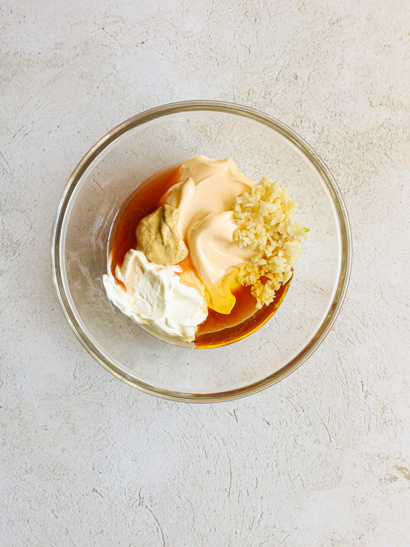 dressing ingredients in a glass bowl.