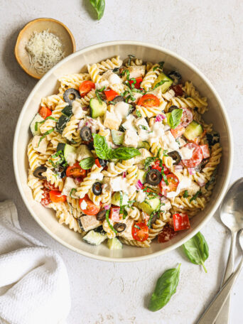 pasta salad with chicken in a white bowl.