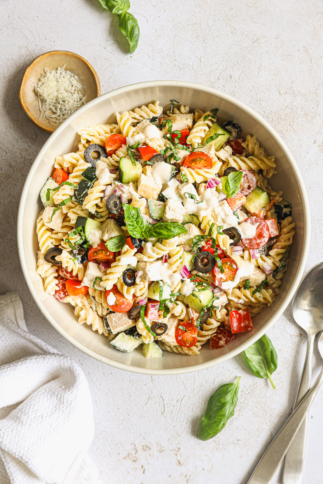 pasta salad with chicken in a white bowl.