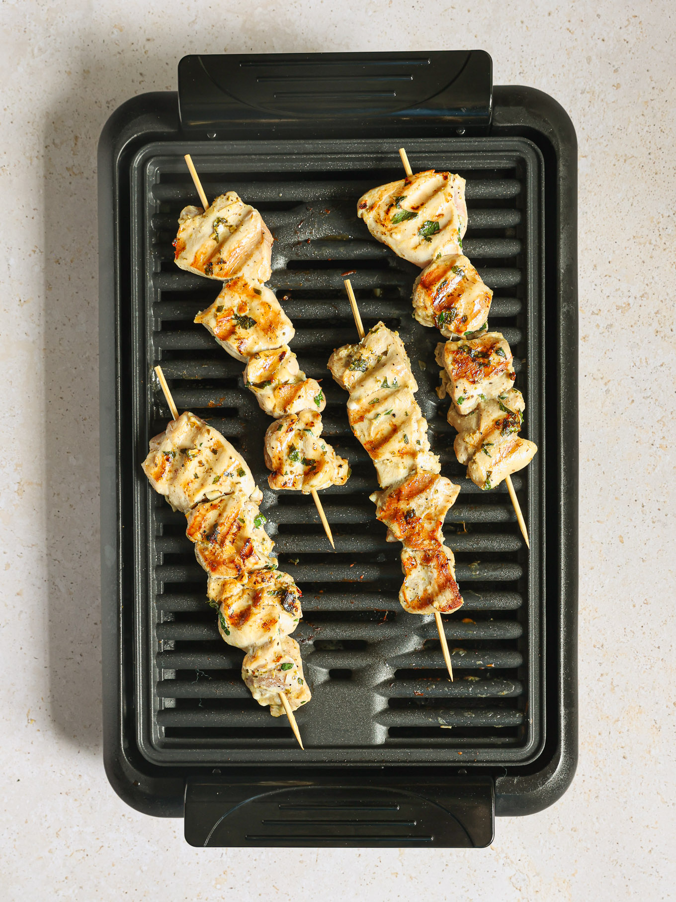 grilled chicken kabobs on a grill.