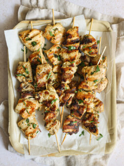 grilled chicken kabobs on tray.