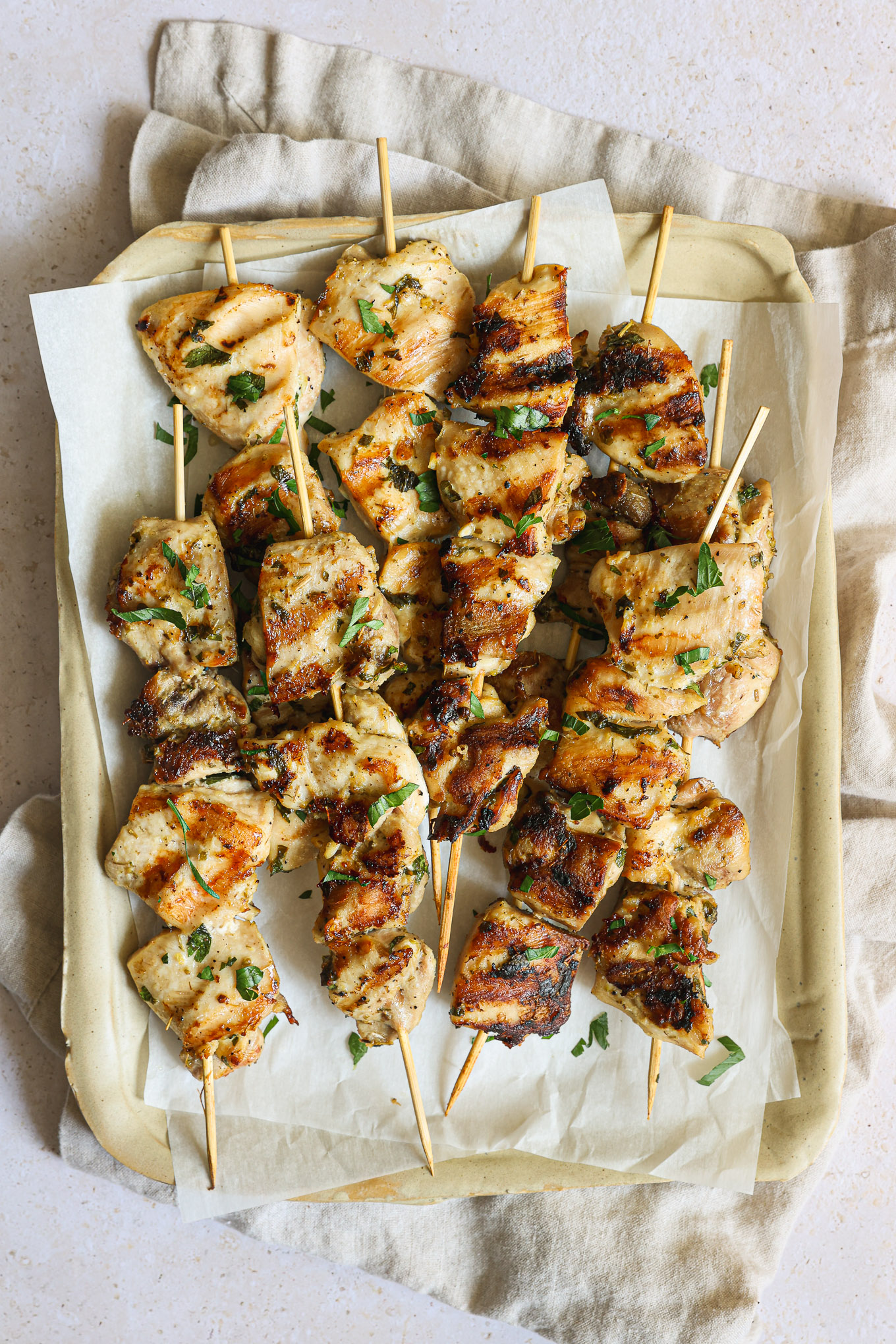 grilled chicken kabobs on tray.