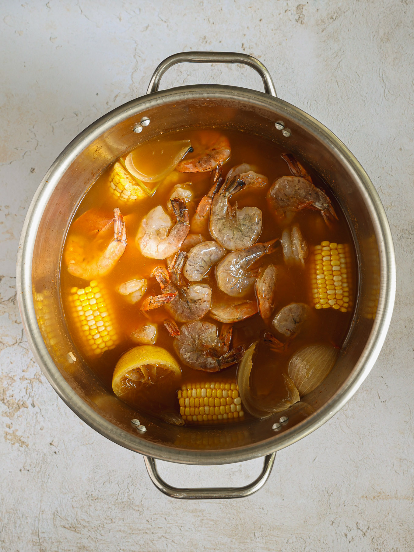 shrimp in broth in a large stock pot.