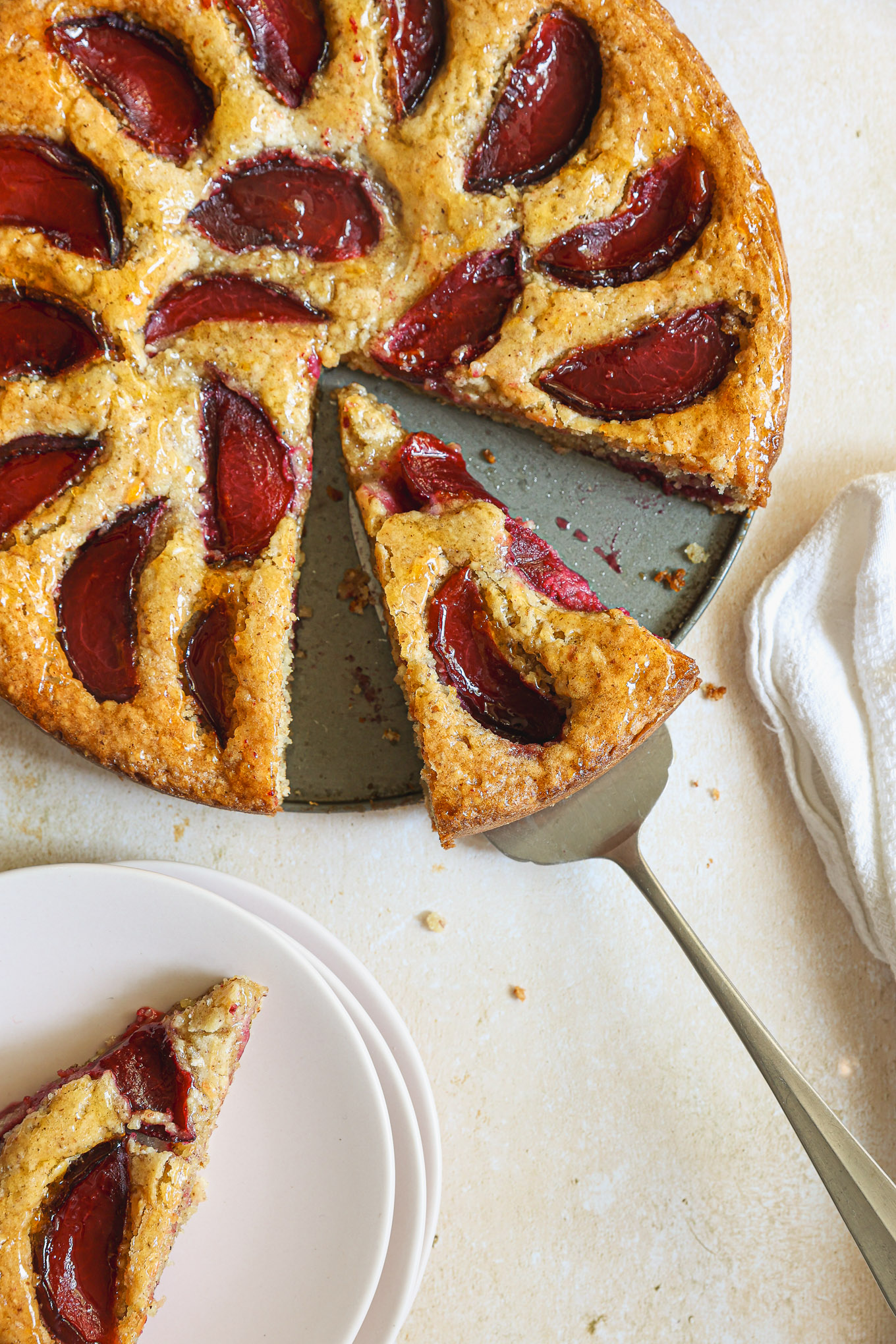 close up sliced torte with plums.
