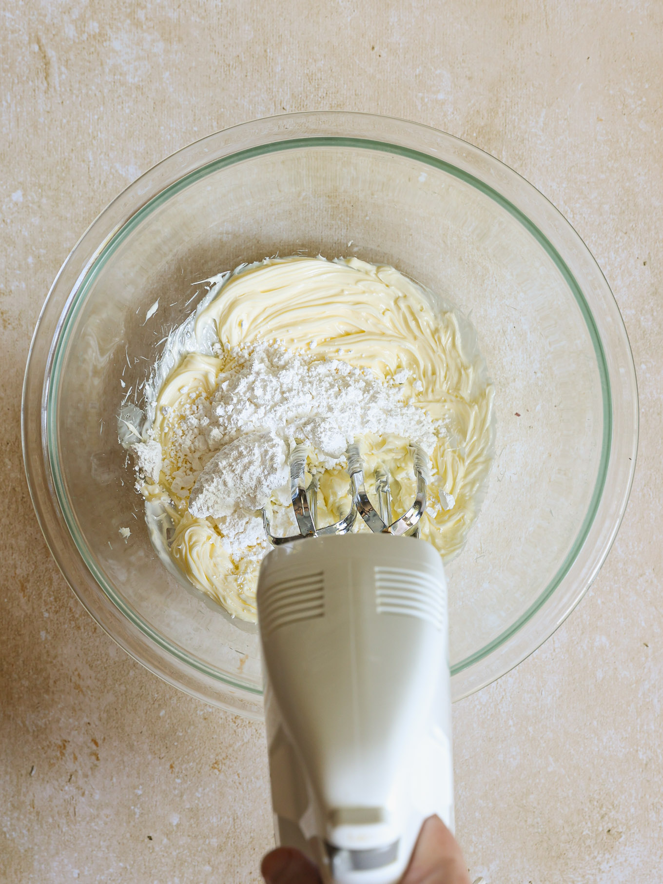 whipped butter and confectioners' sugar in a glass bowl.