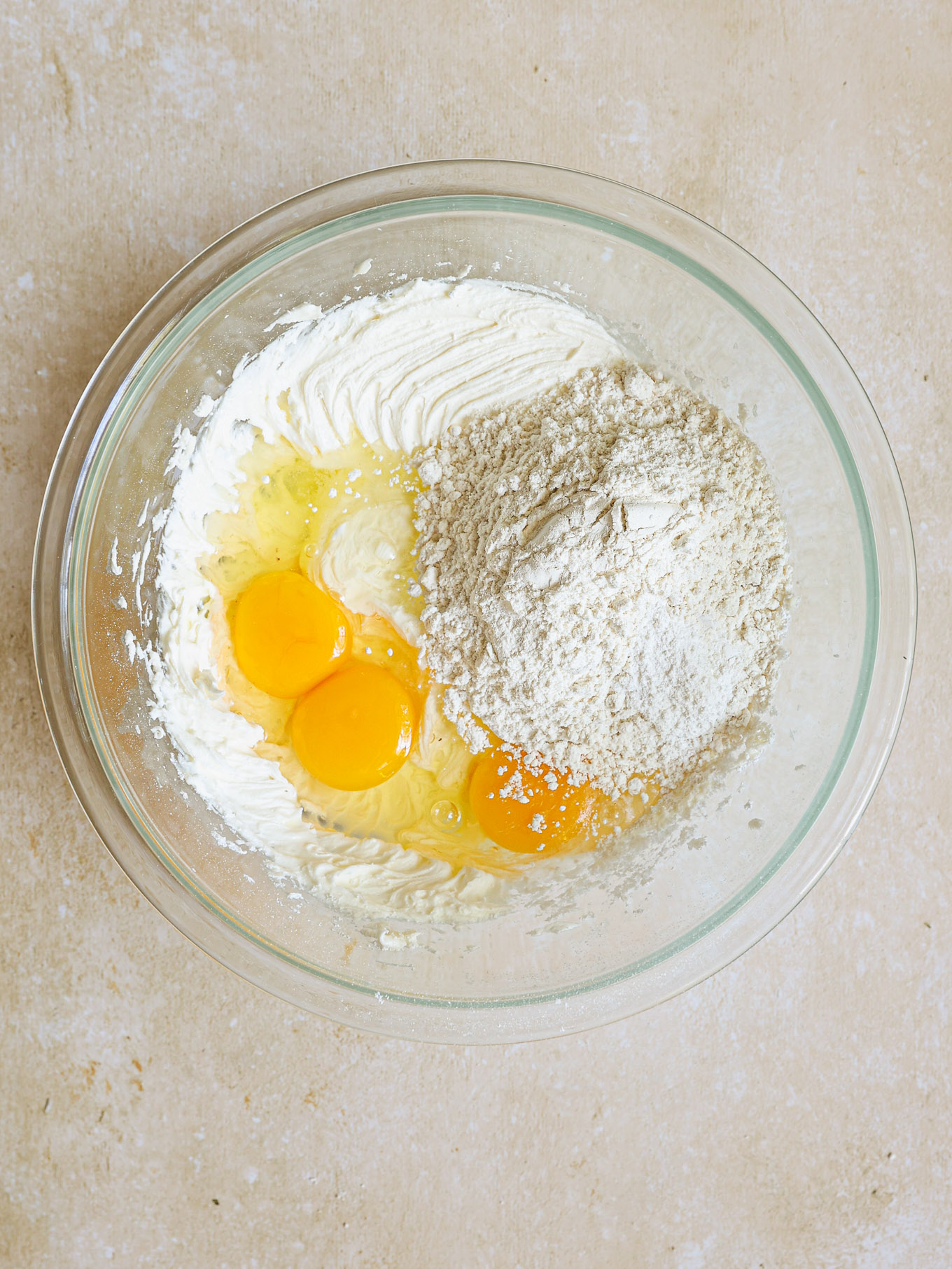 eggs and flour in a glass bowl.