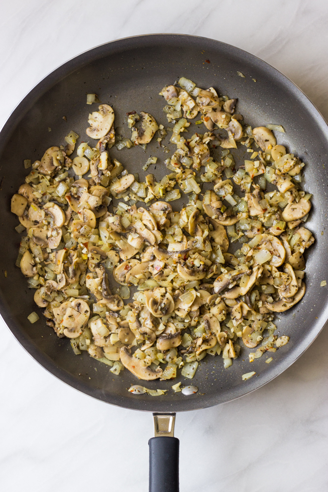 cooked mushrooms with spices in a skillet.