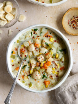 scallop chowder in a bowl garnished with parsley.