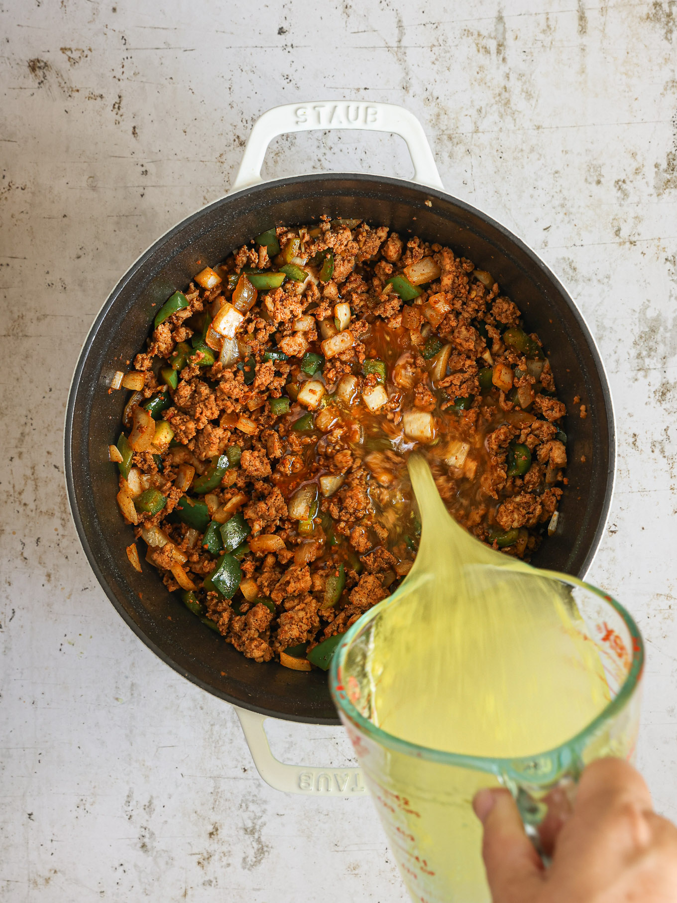 broth with cooked ground turkey in a pot.