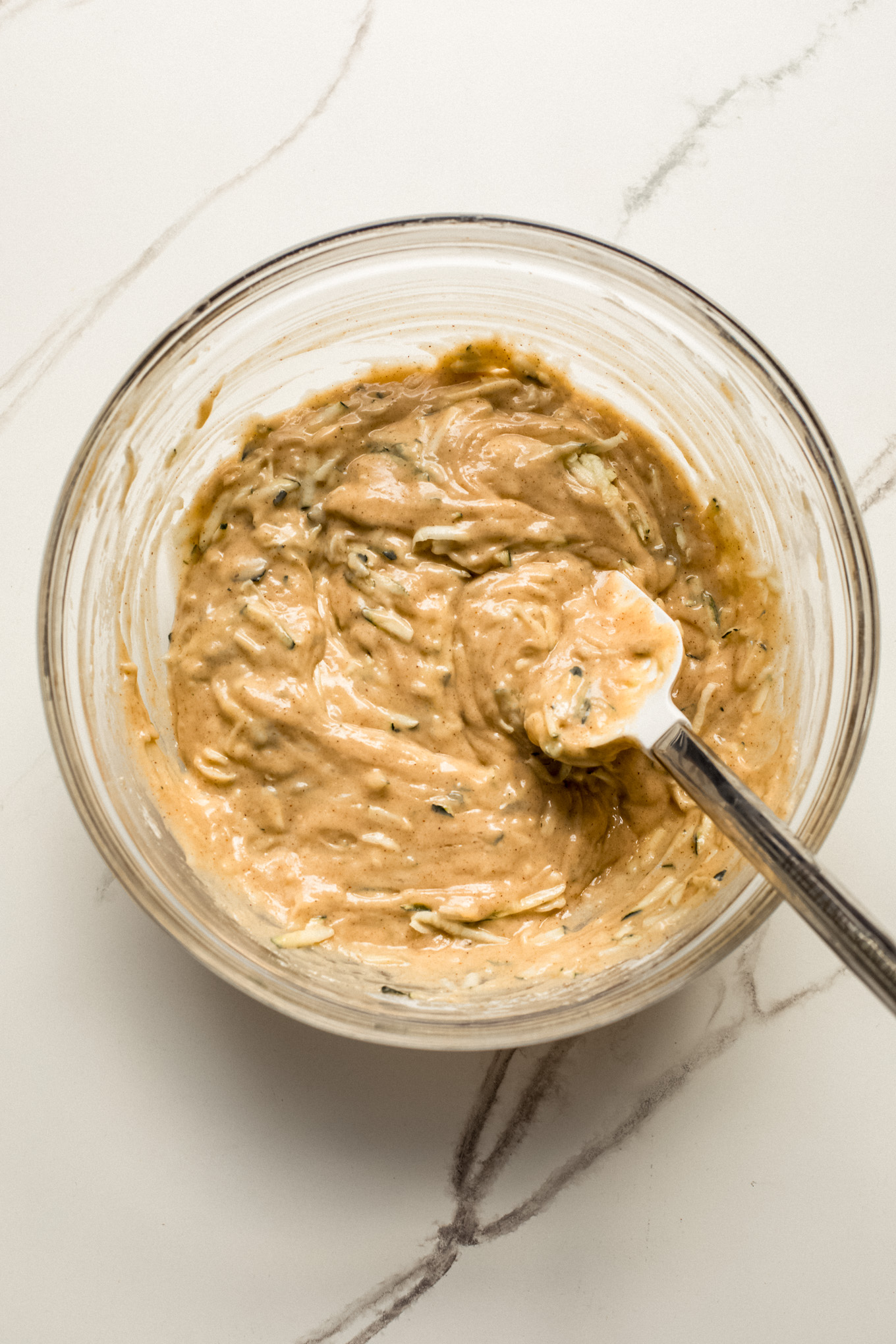 mixed batter for zucchini bread in a bowl.