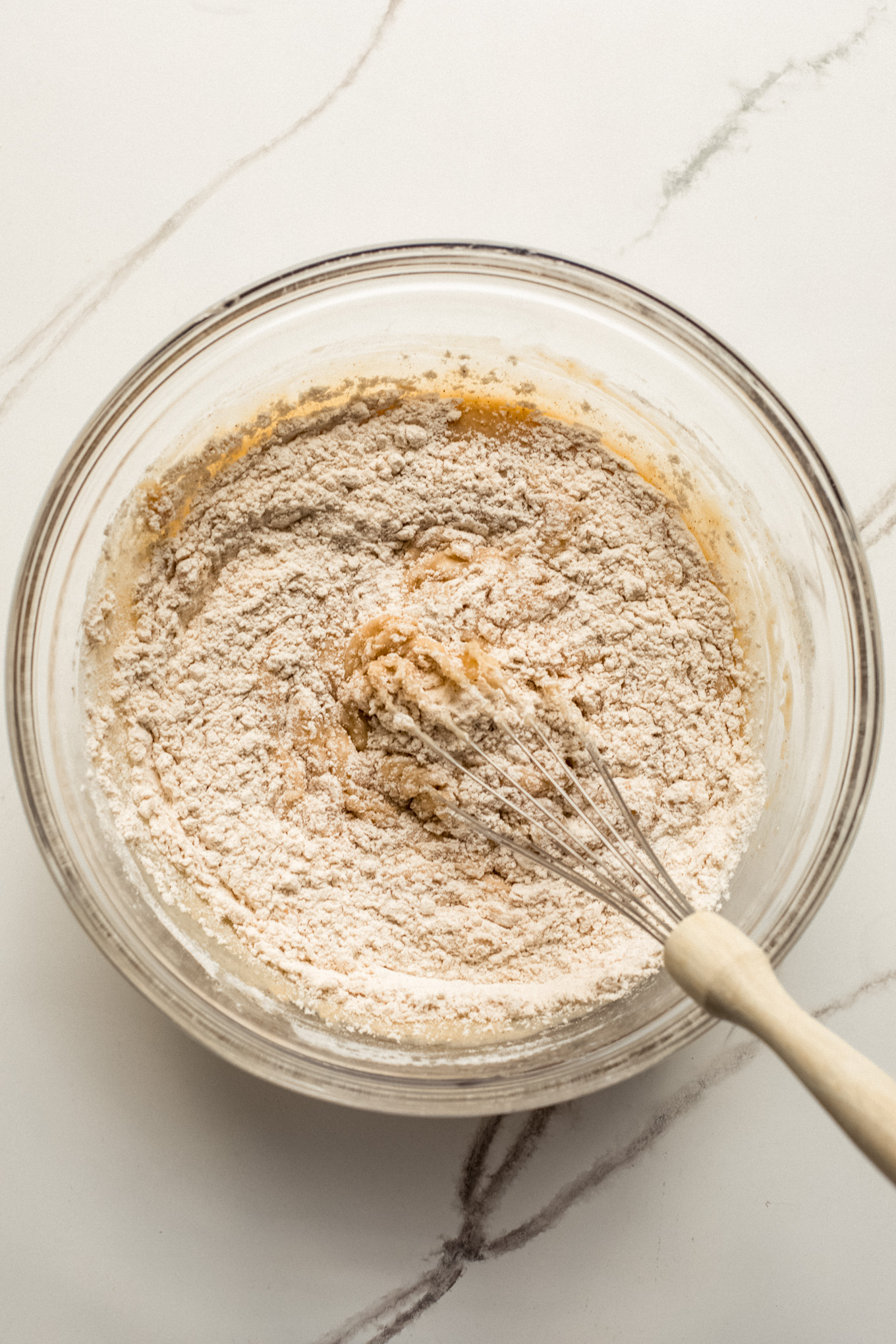 wet and dry ingredients combined in a glass bowl.