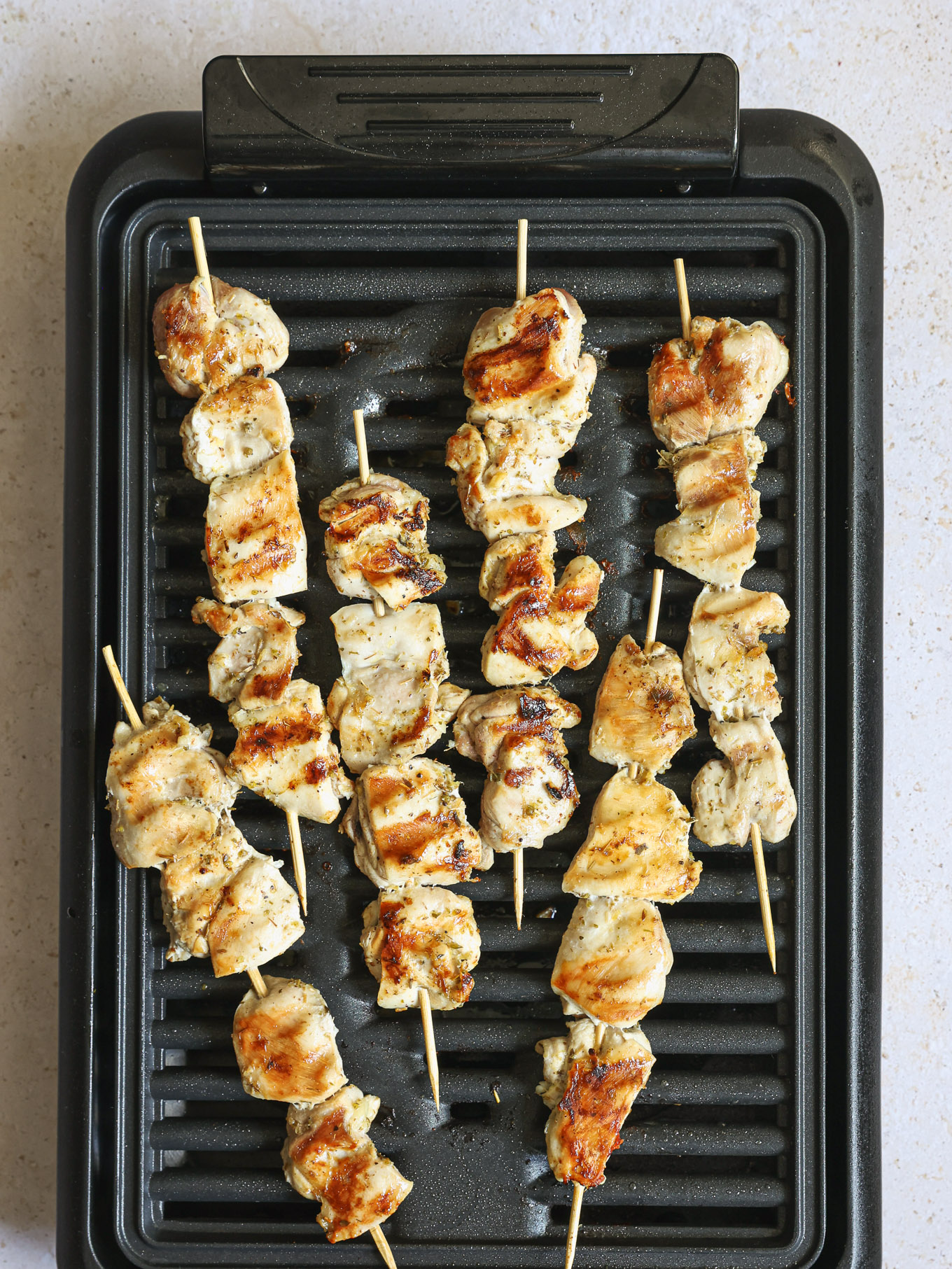 grilled chicken skewers on a grill.