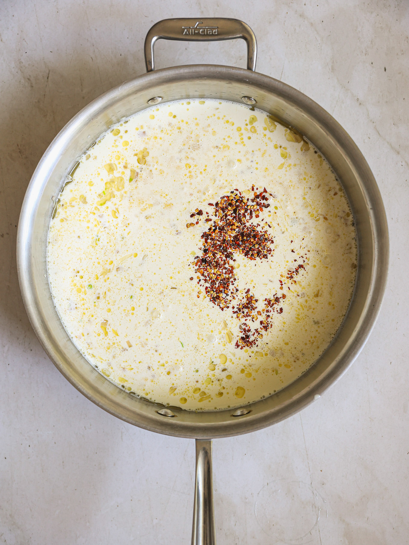 cream with red pepper in saute pan.