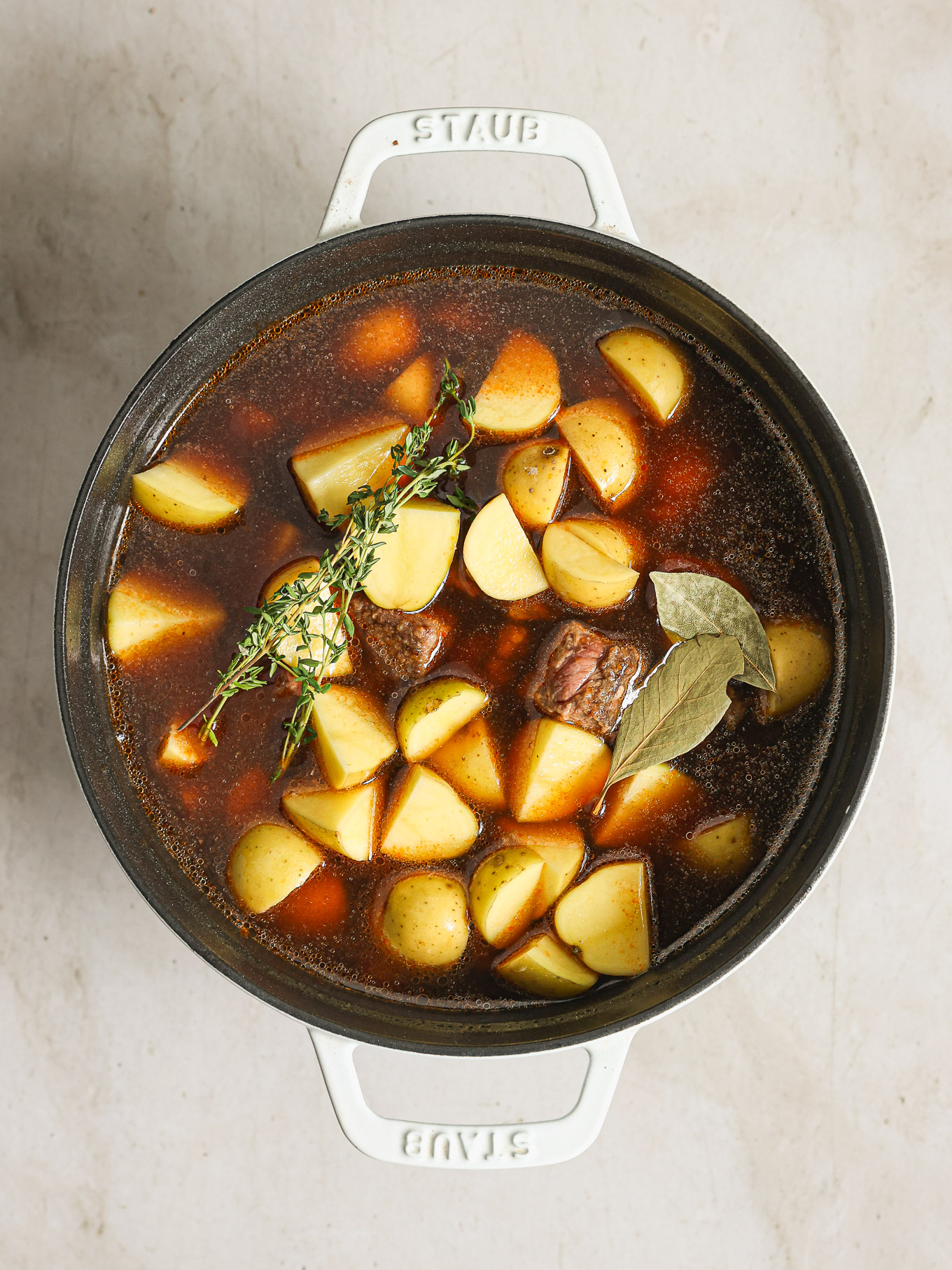 potatoes with beef in a dutch oven.