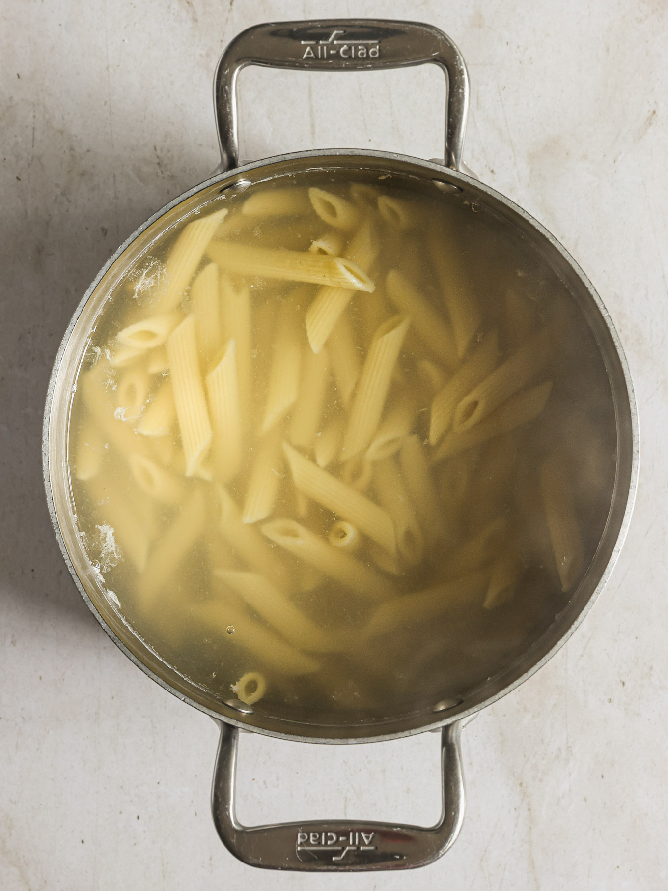 cooked penne pasta in a pot of water.