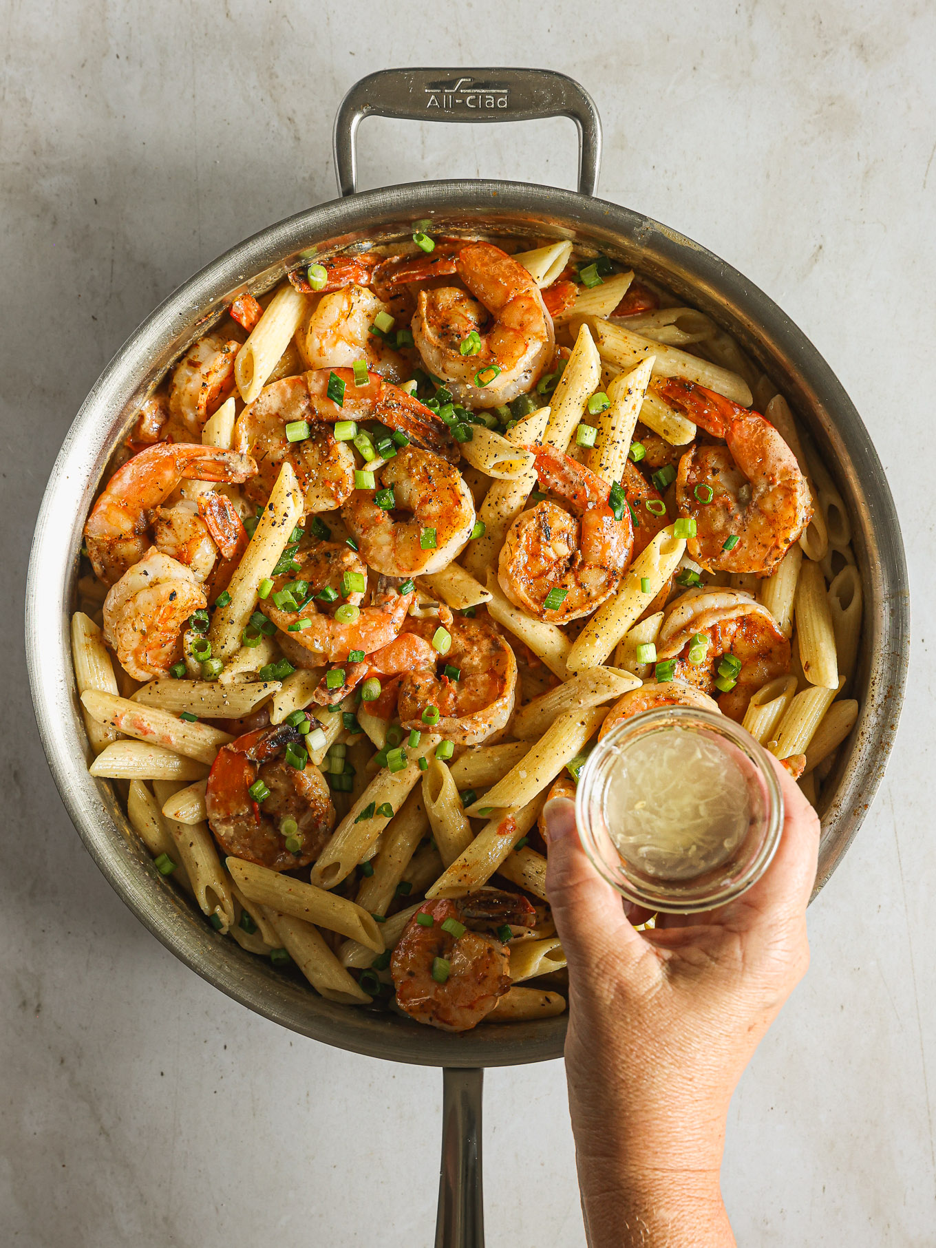 cajun shrimp pasta garnished with green onions.