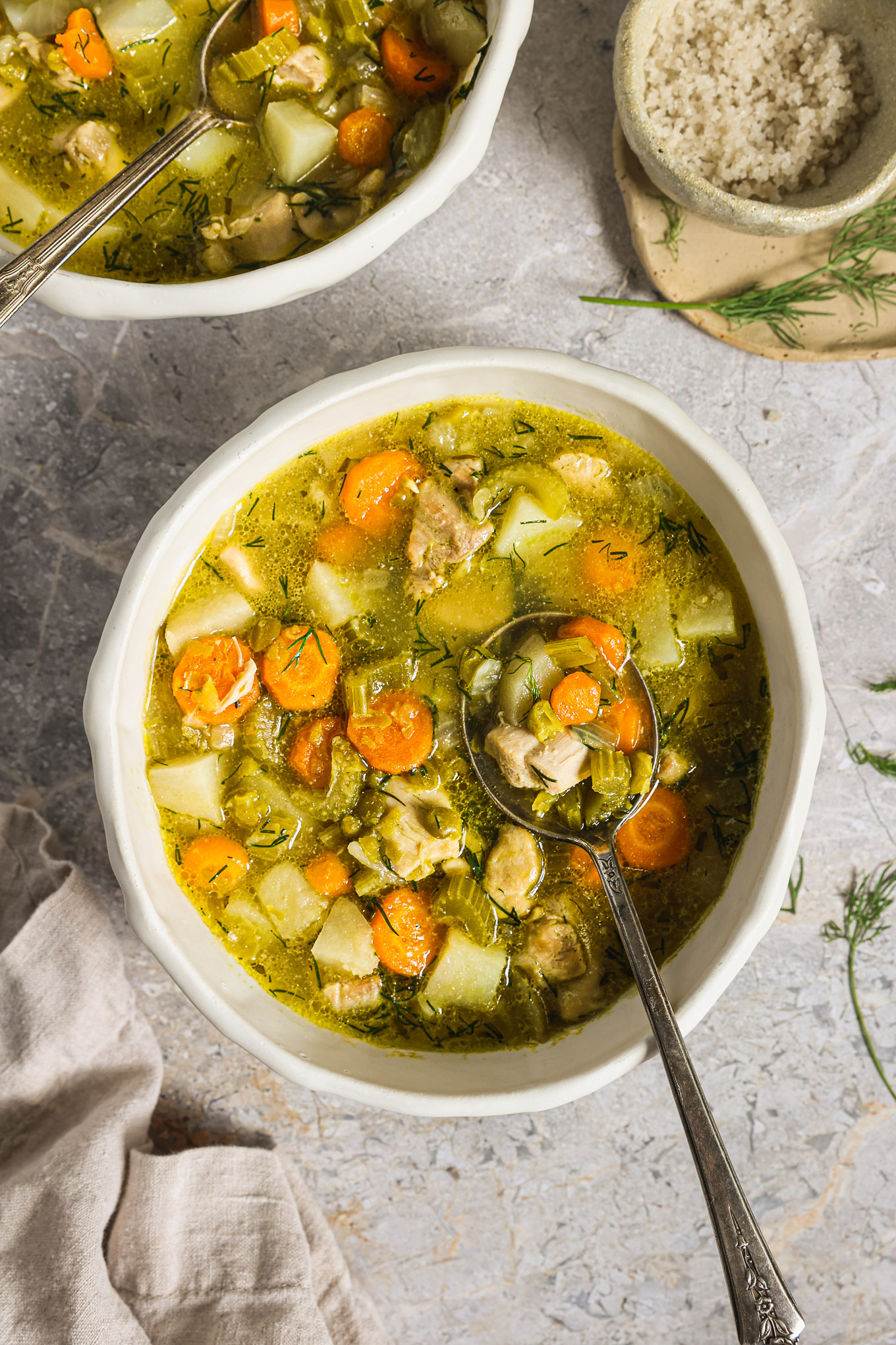green split pea soup garnished with dill.