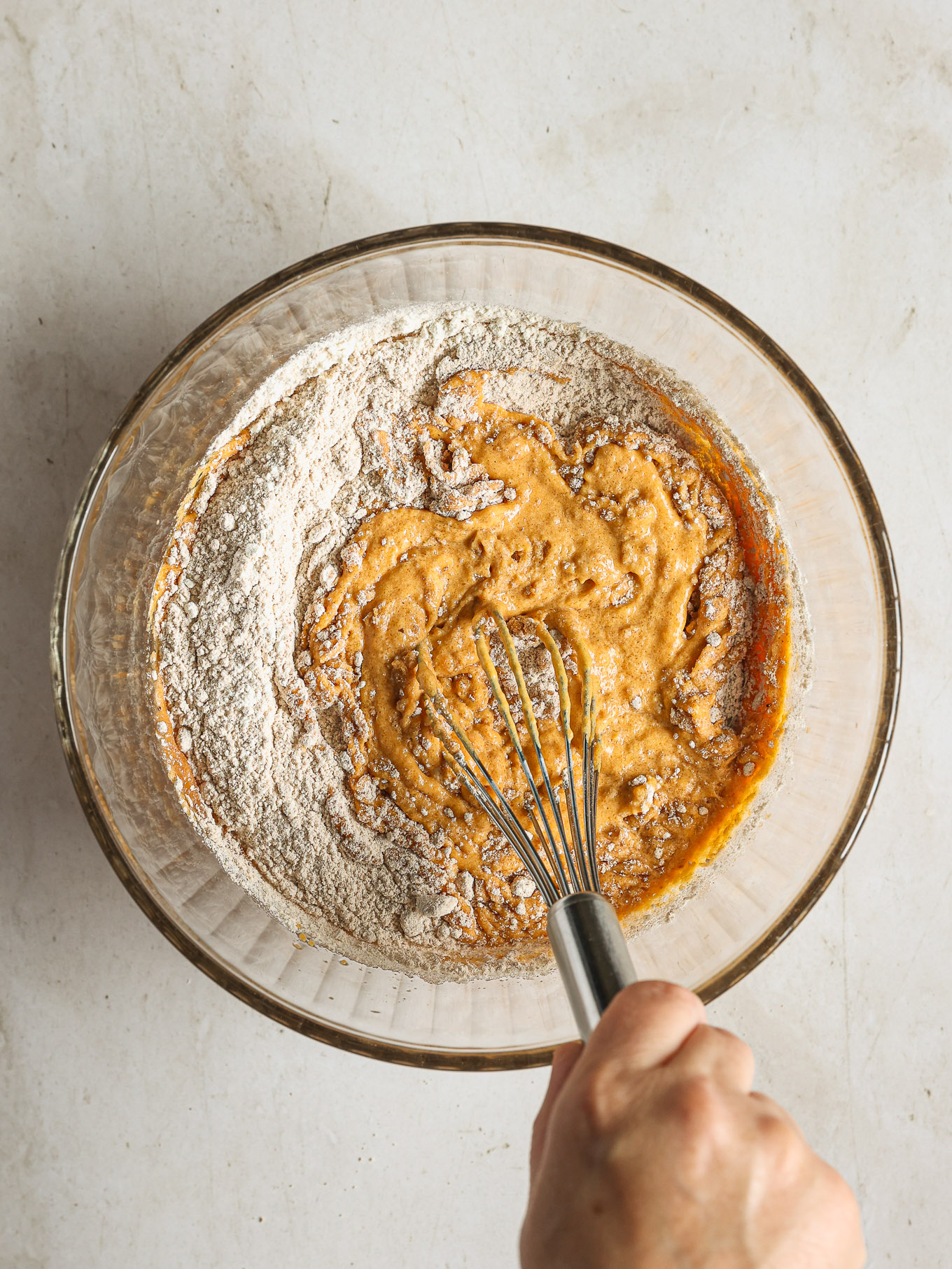 dry and wet ingredients mixed together in a bowl.