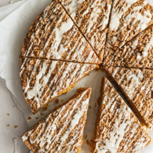 sliced pumpkin coffee cake on white board.