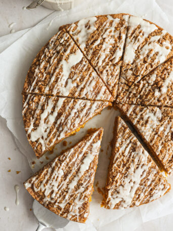 sliced pumpkin coffee cake on white board.