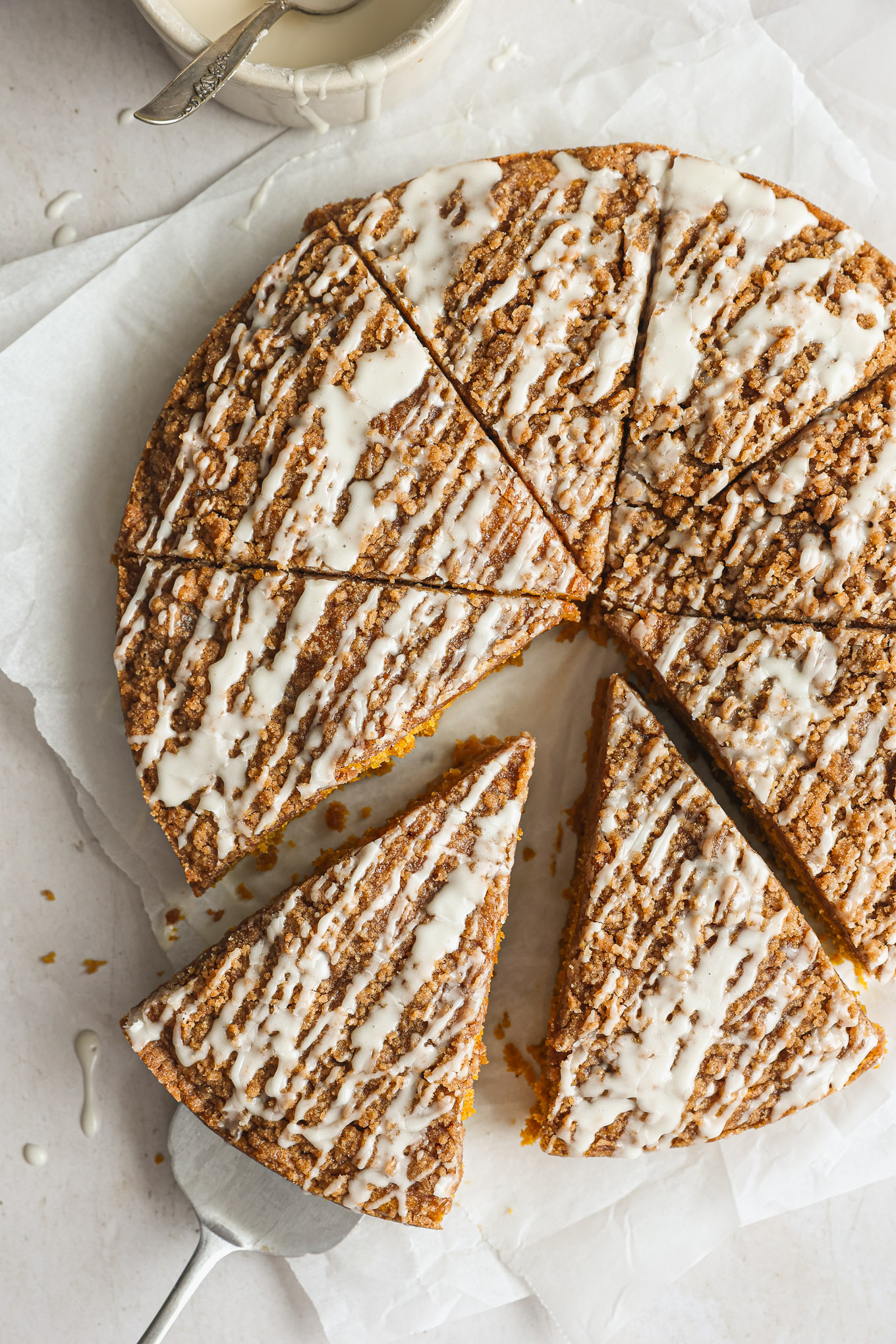 sliced pumpkin coffee cake on white board.