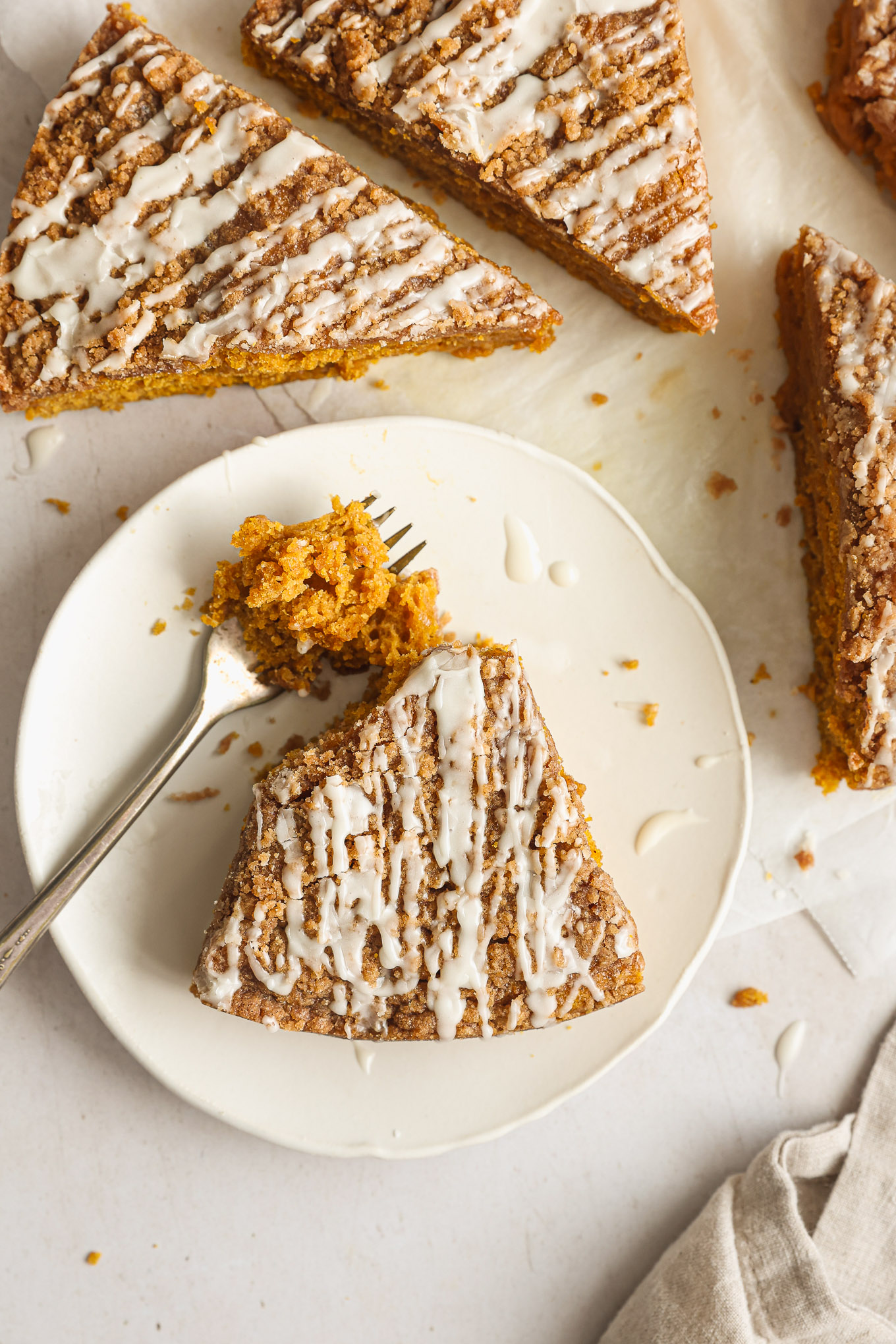 sliced up coffee cake with pumpkin and streusel topping.