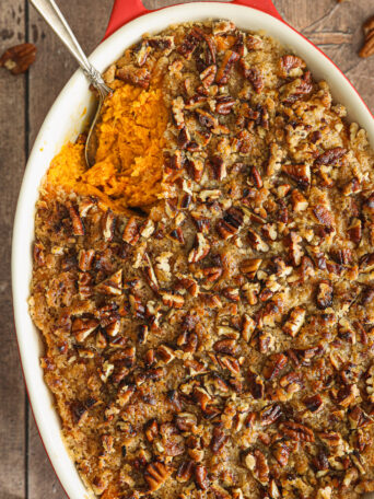 sweet potato casserole with pecan topping in oval casserole.