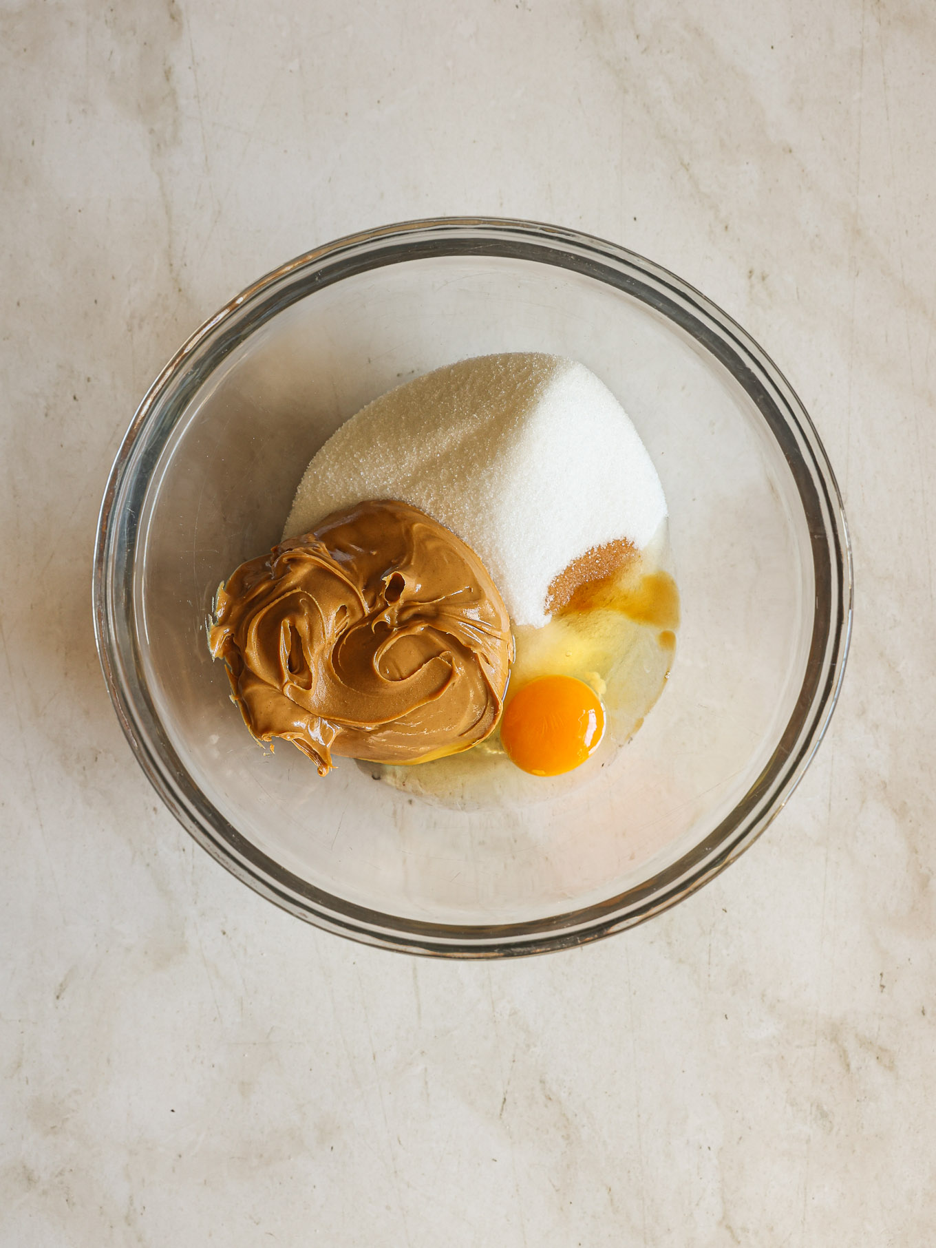 sugar, peanut butter, egg, and vanilla in a mixing bowl.
