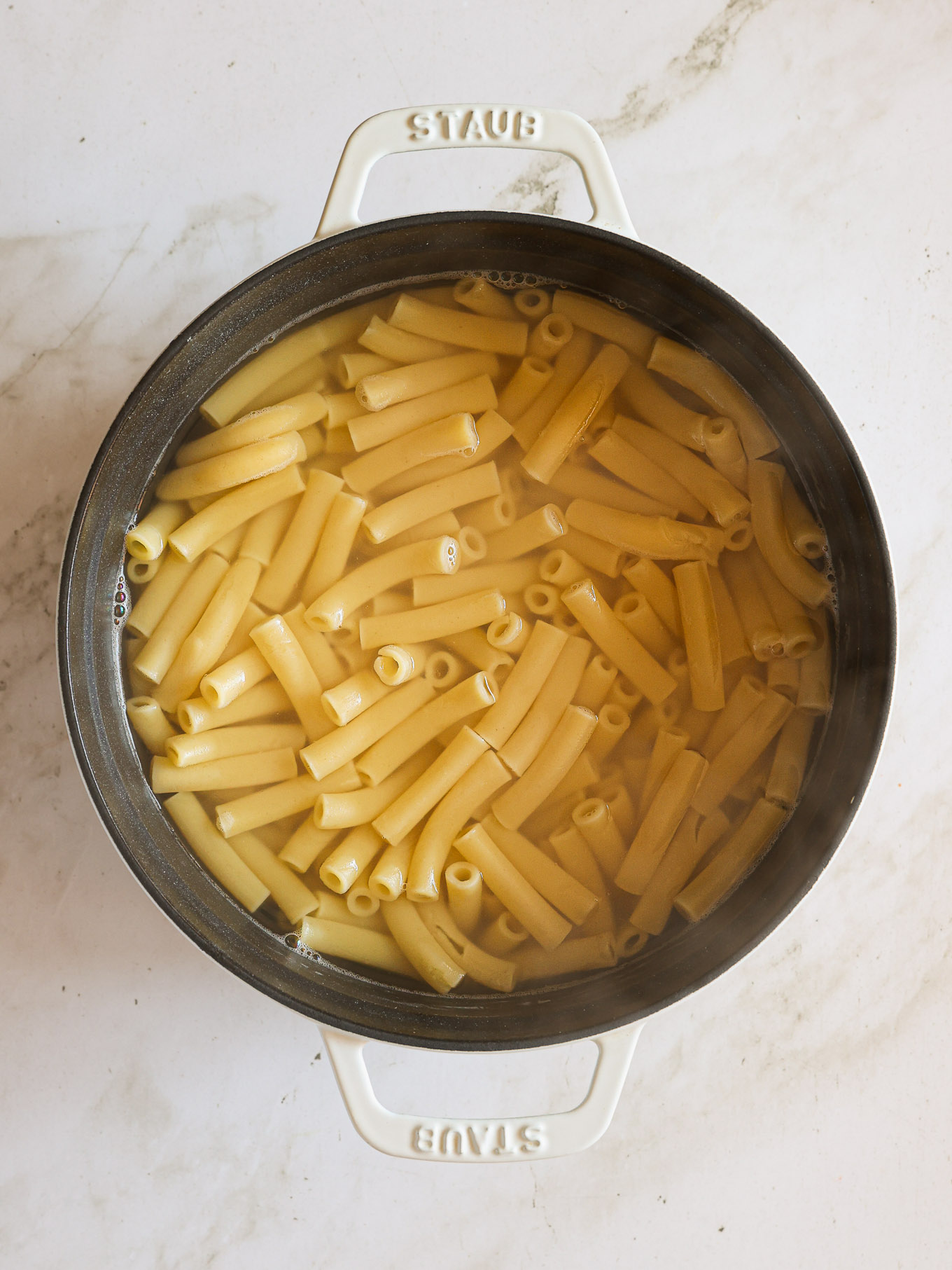 cooked ziti pasta in a pot.