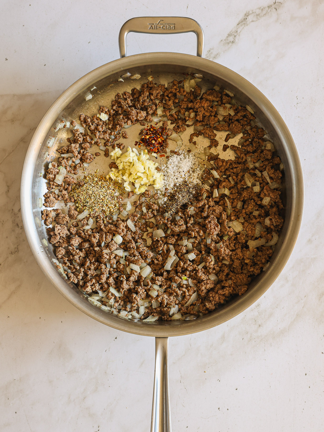 cooked ground beef in a saute pan.