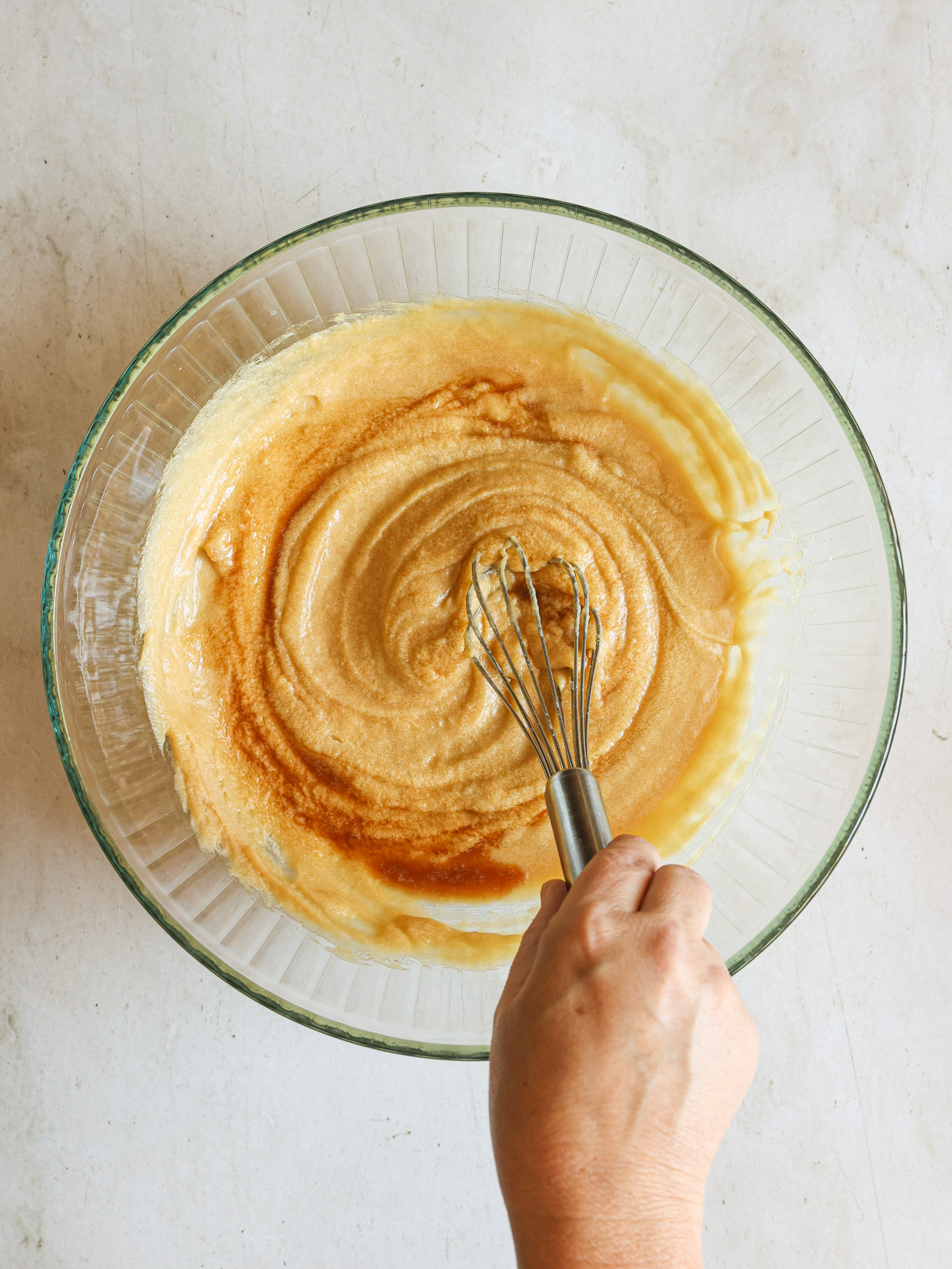 wet and dry ingredients mixed together in a glass bowl.