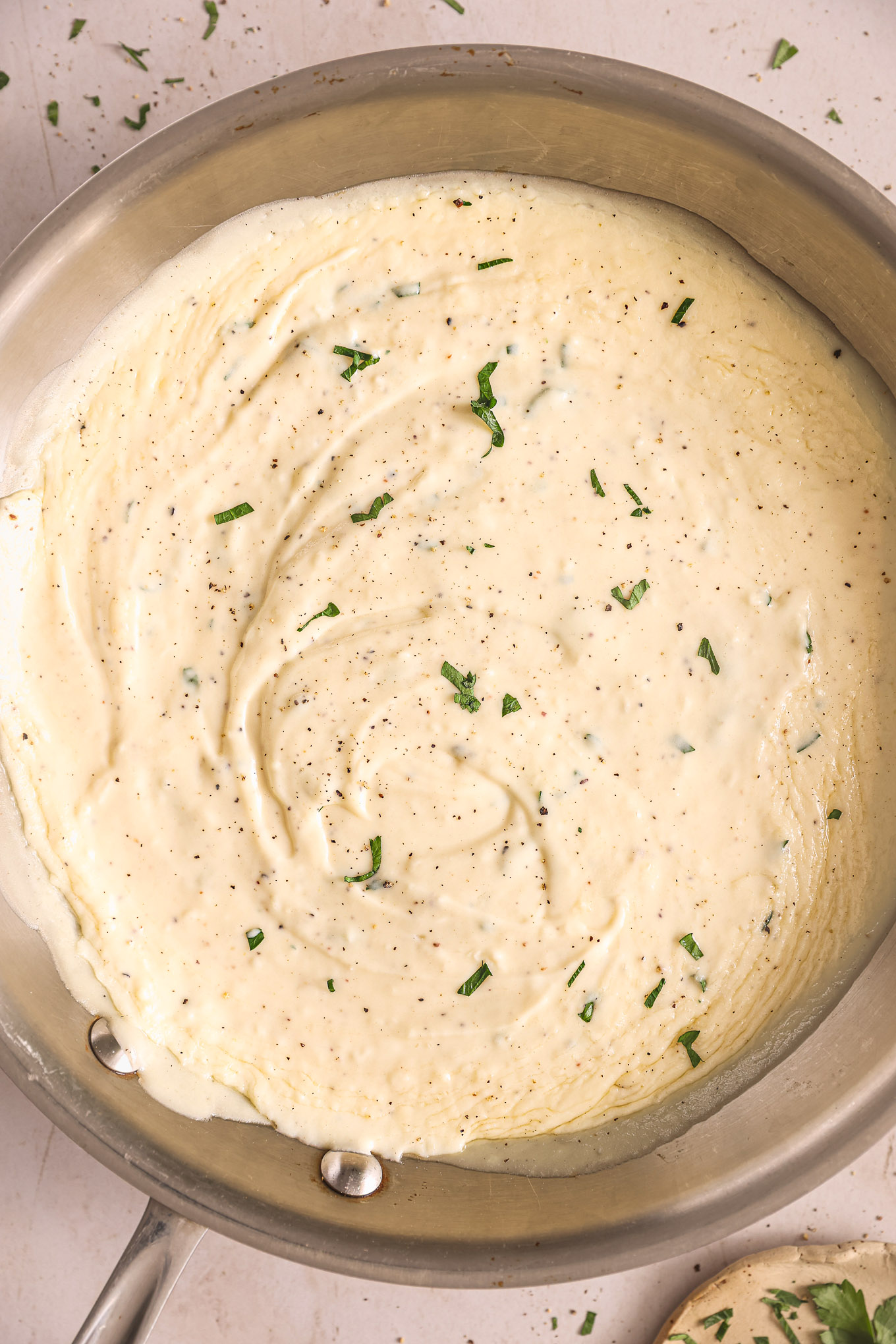 homemade alfredo sauce recipe in a saute pan.