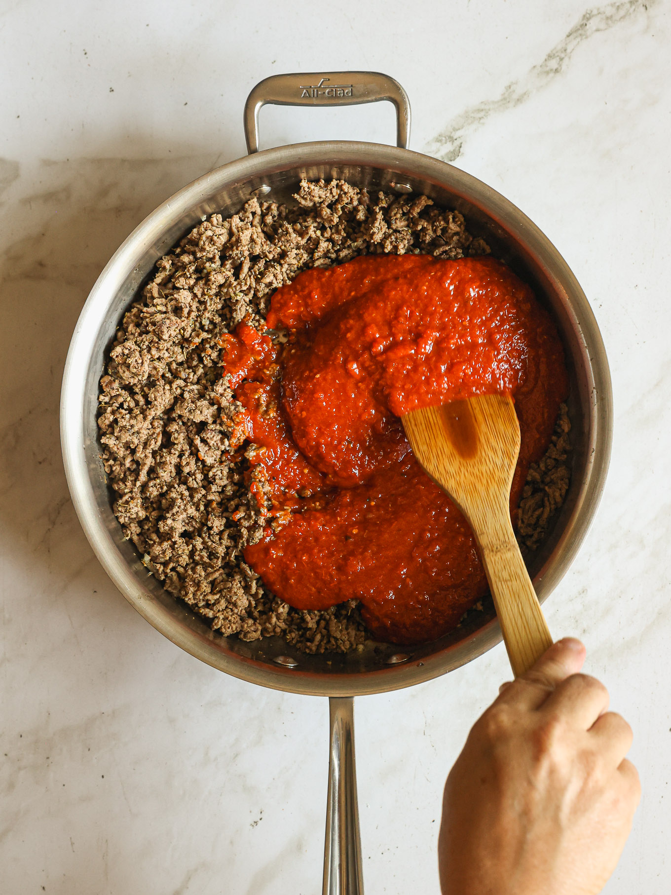 cooked ground beef and sauce in a skillet.