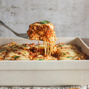 baked spaghetti in a white casserole dish.