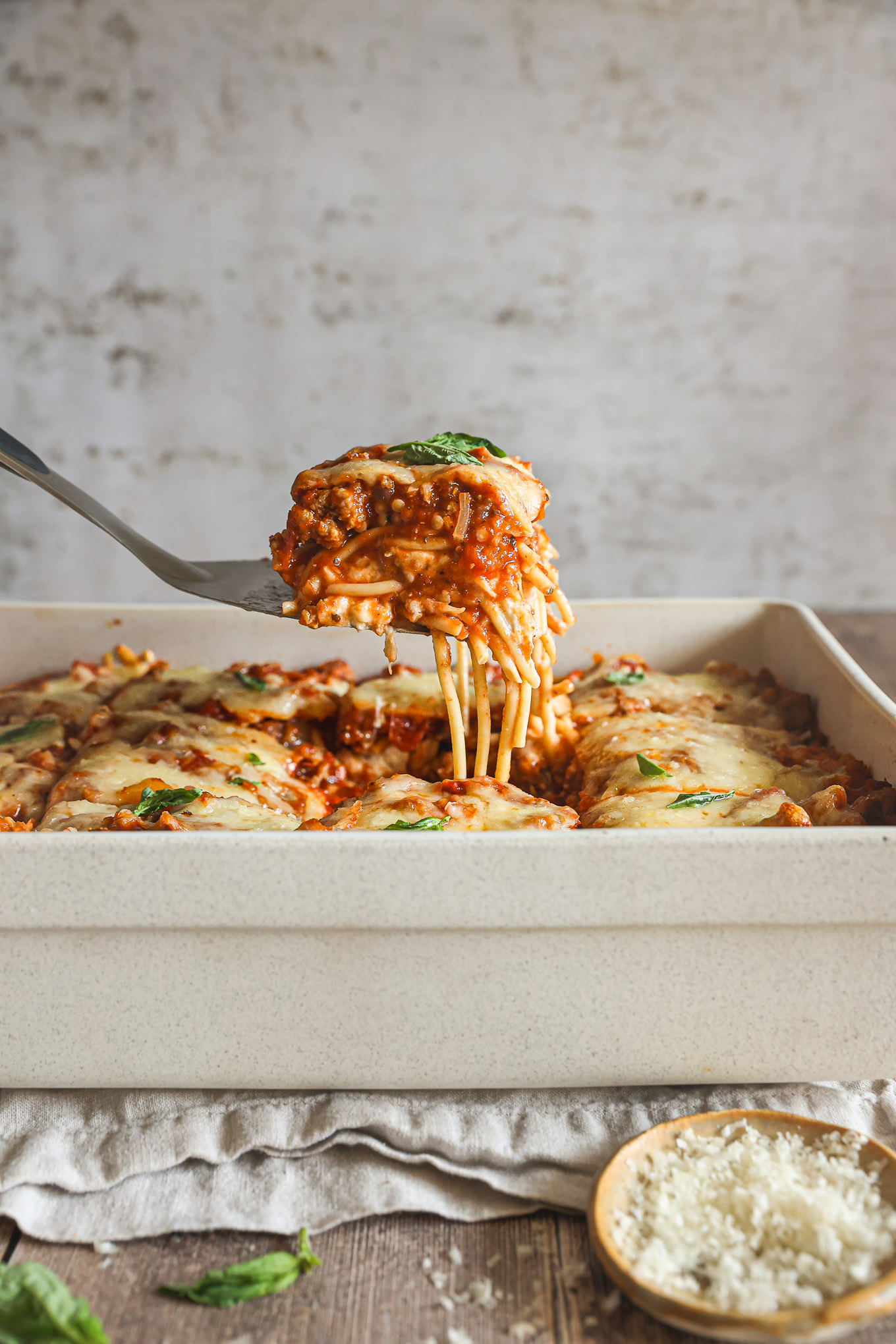 baked spaghetti in a white casserole dish.