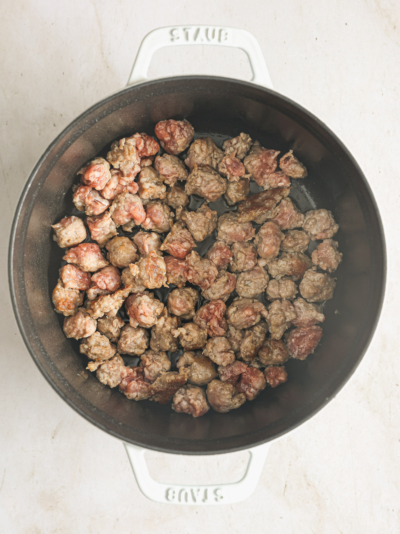 cooked sausage in a soup pot.