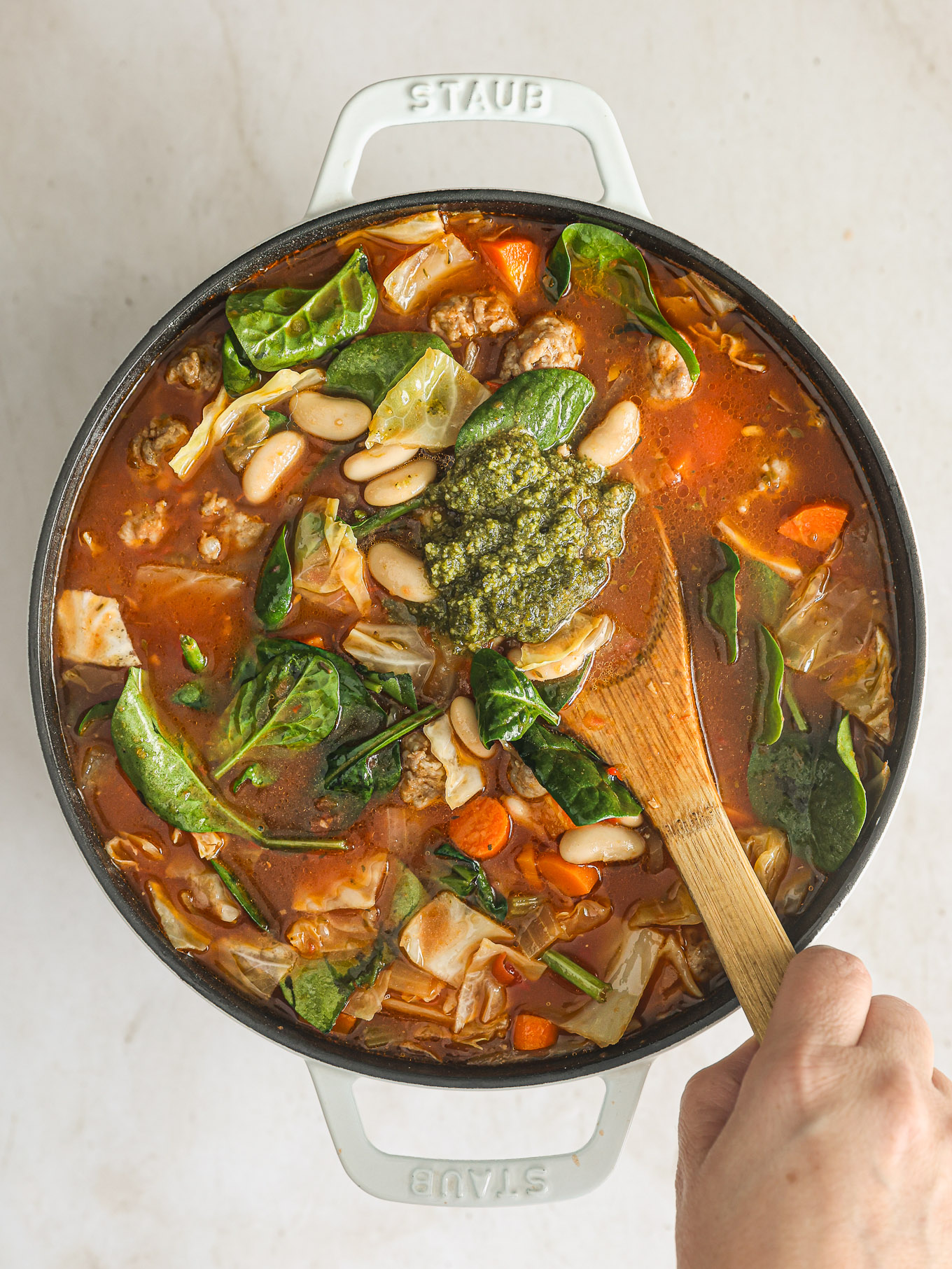 basil pesto going into cabbage soup.