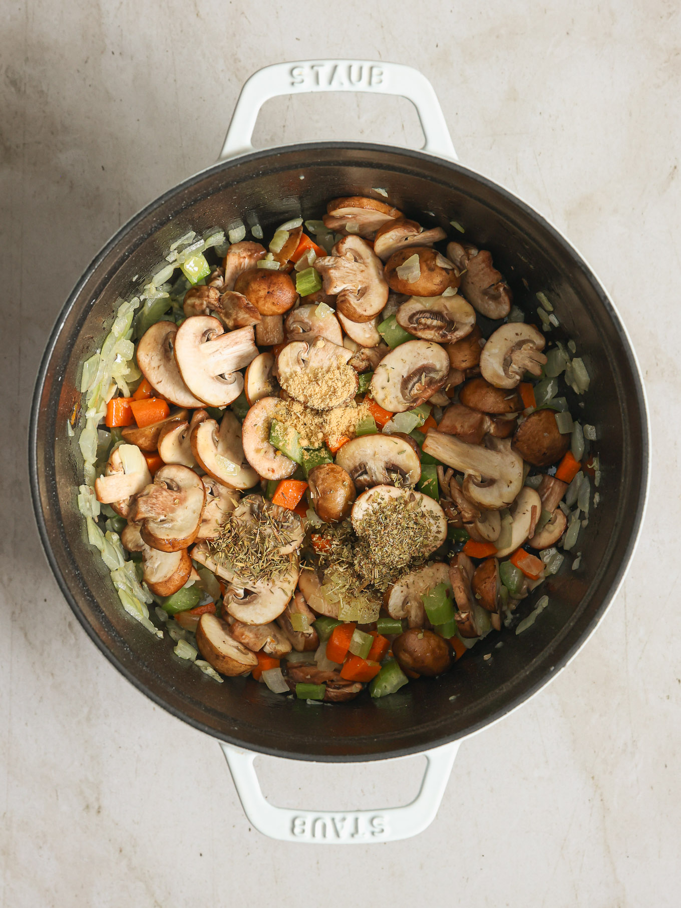 sliced mushrooms with spices in a soup pot.