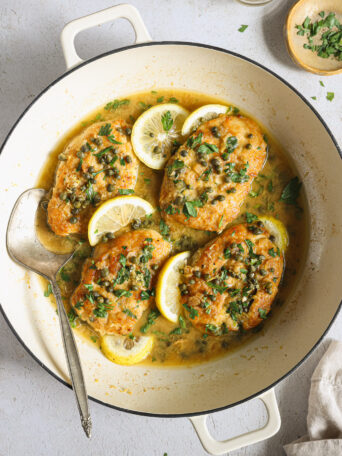 lemon chicken piccata in a skillet.