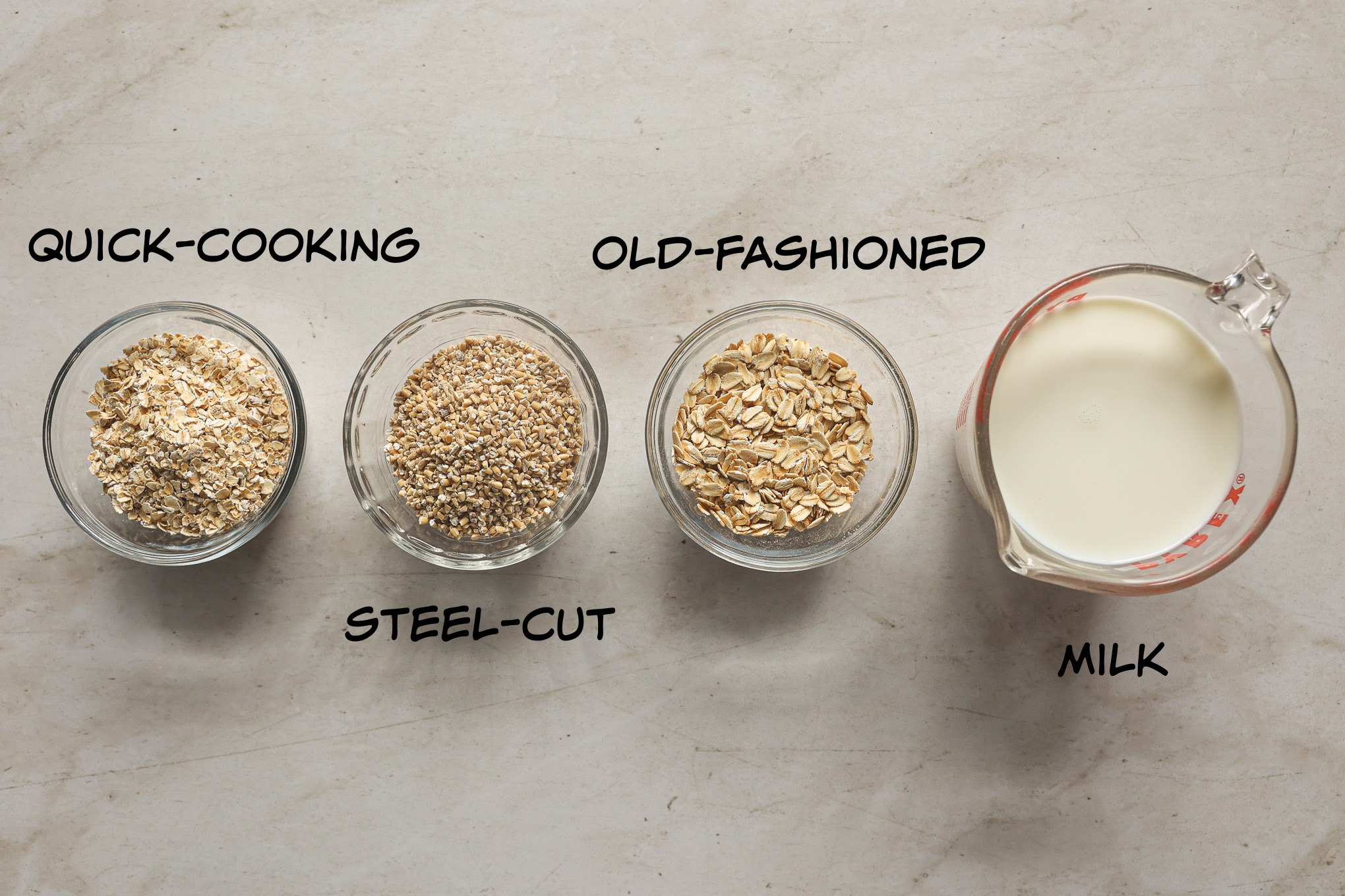 three types of oats in glass bowls.