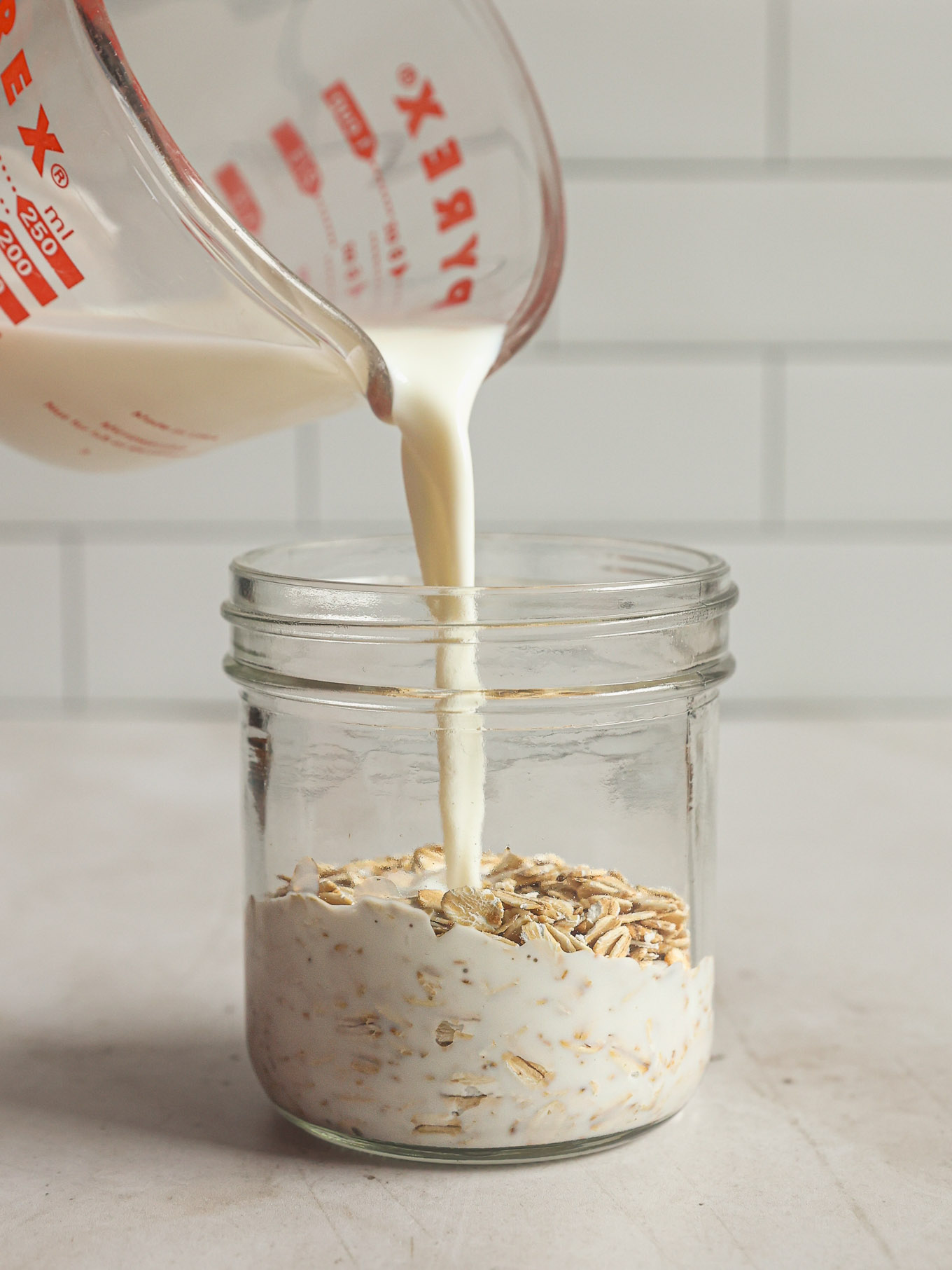 milk being poured over dry oats.