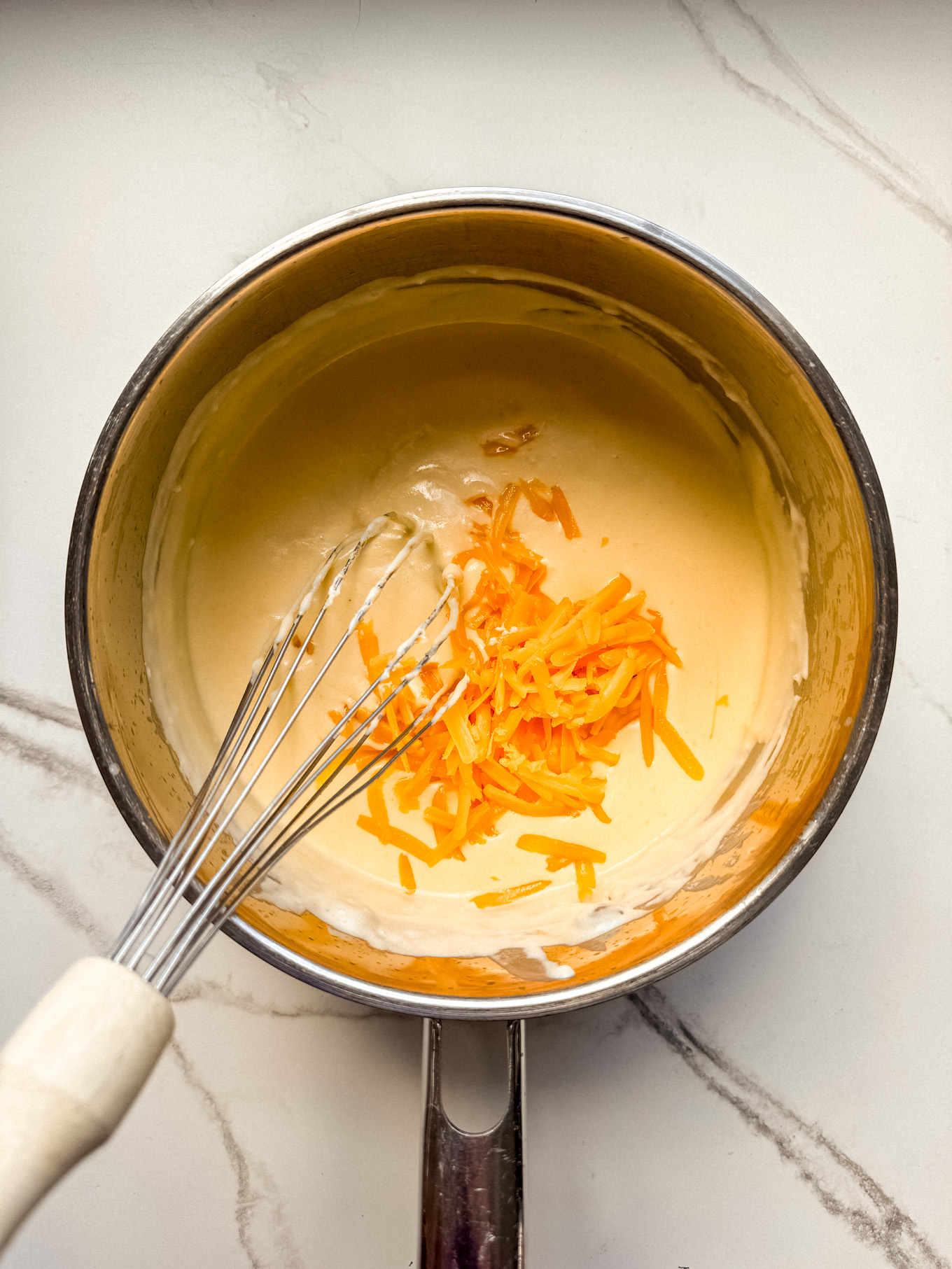 grated cheese whisked into cream.