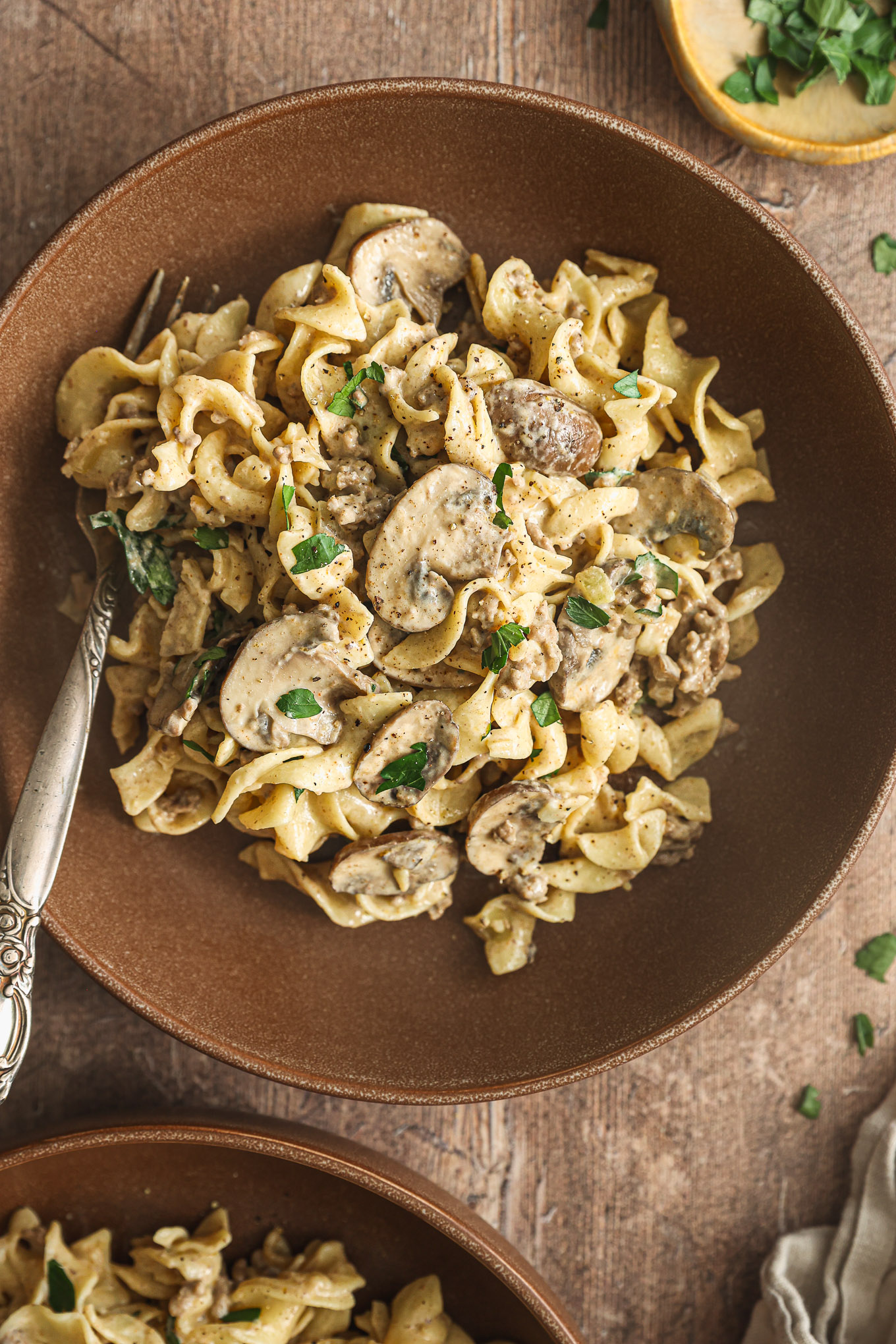 egg noodles with ground beef and mushrooms in a bowl.