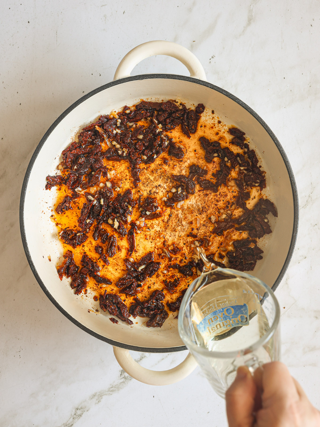 garlic and sun dried tomatoes in skillet.