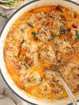 chicken in cream sauce in a skillet.