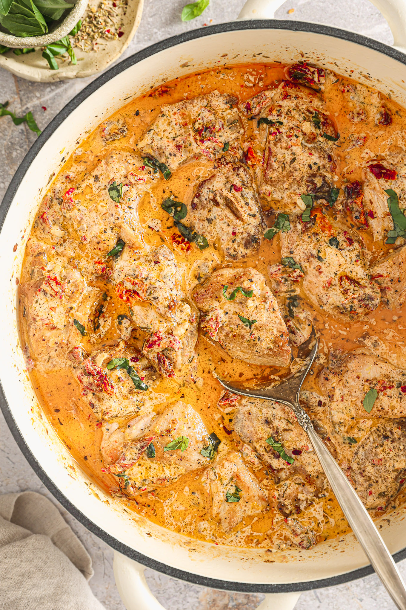 chicken in cream sauce in a skillet.