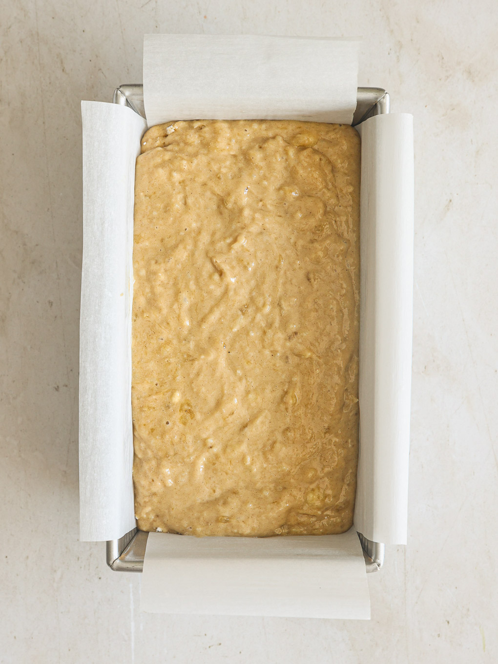 banana bread batter in a loaf pan.