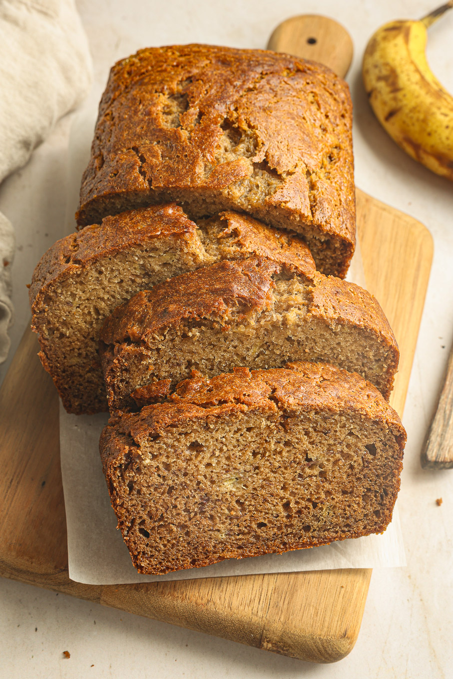 sliced banana bread on cutting board.