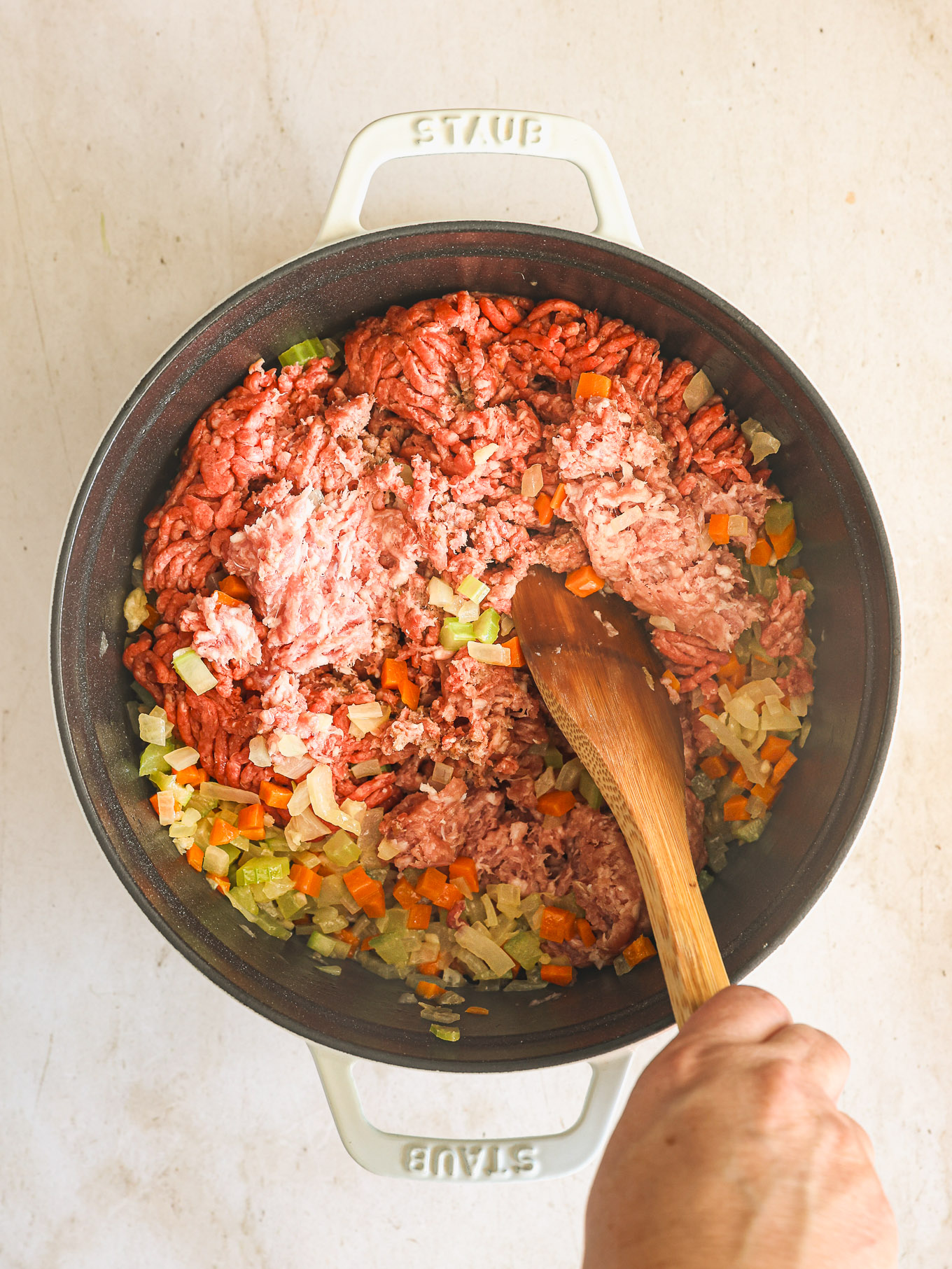 ground beef and pork in a dutch oven.
